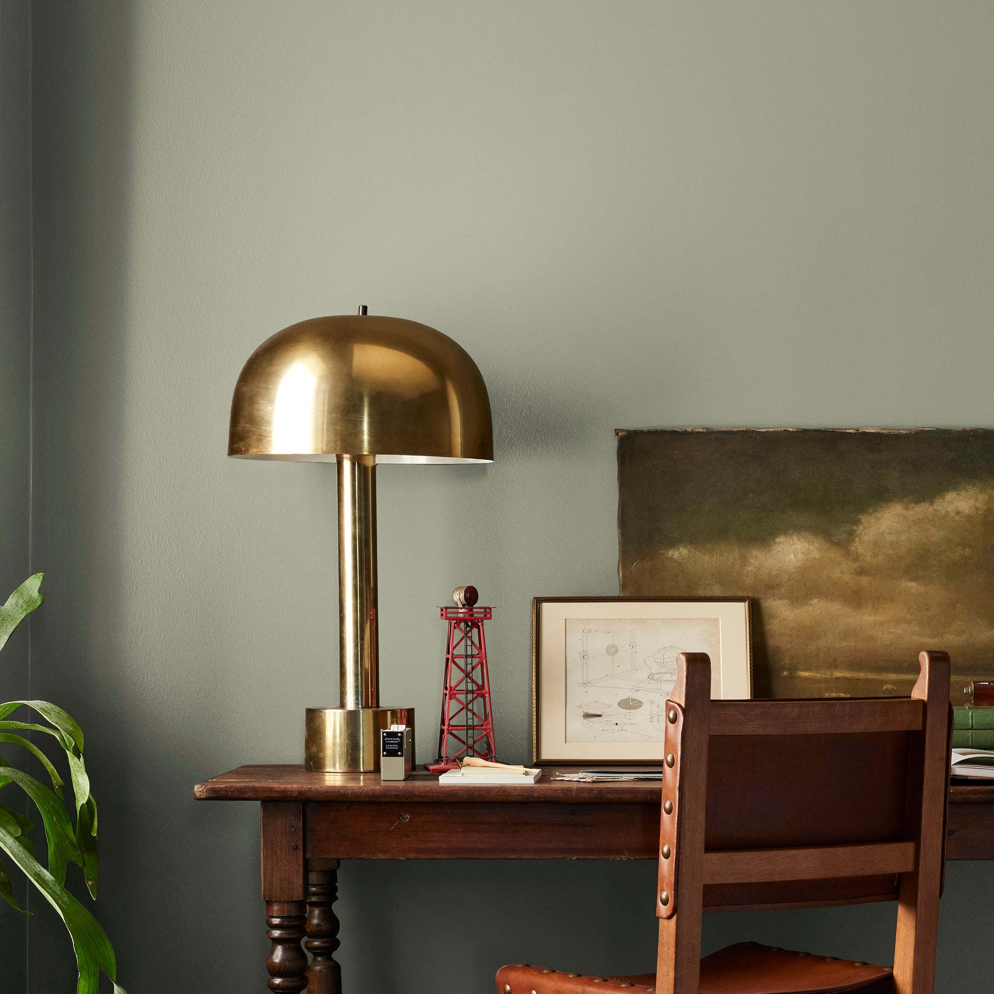 dark grey-green interior paint named garden essential shown painted on bedroom wall