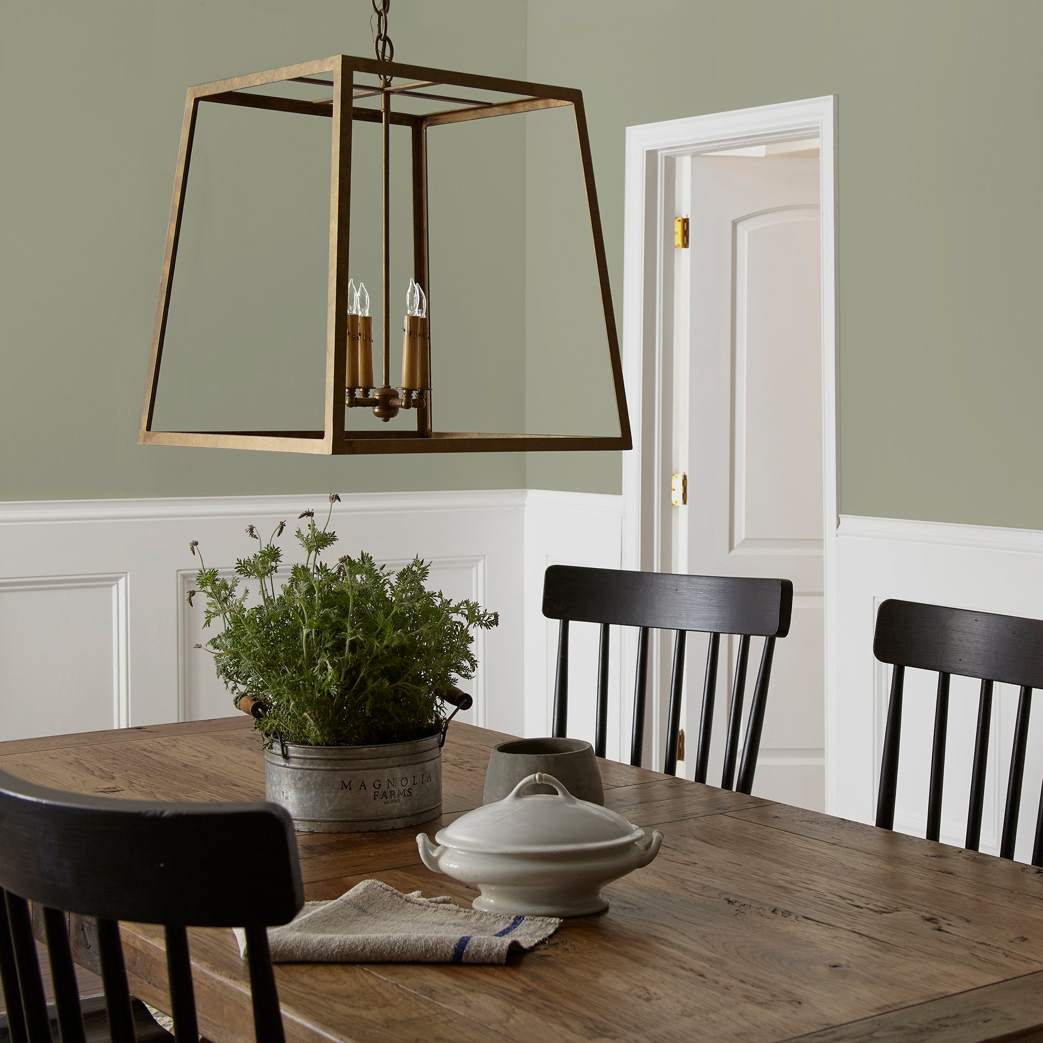 dark grey-green interior paint named garden essential shown painted on dining room wall