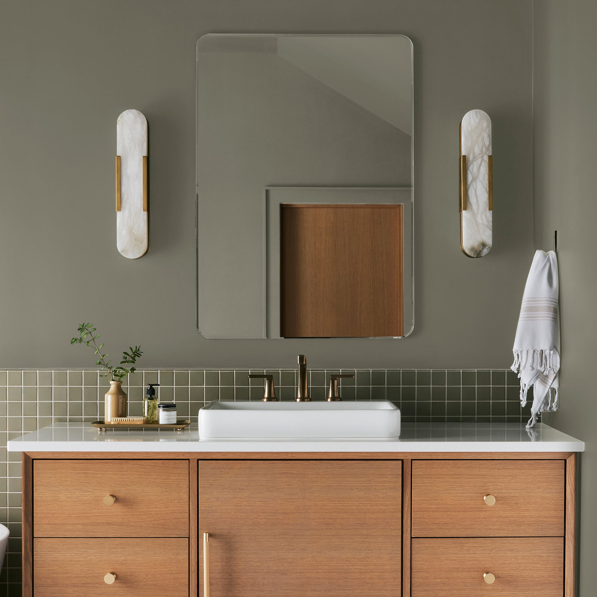 Lighter shade of army green with notes of hazel interior paint named garden party shown painted on bathroom wall