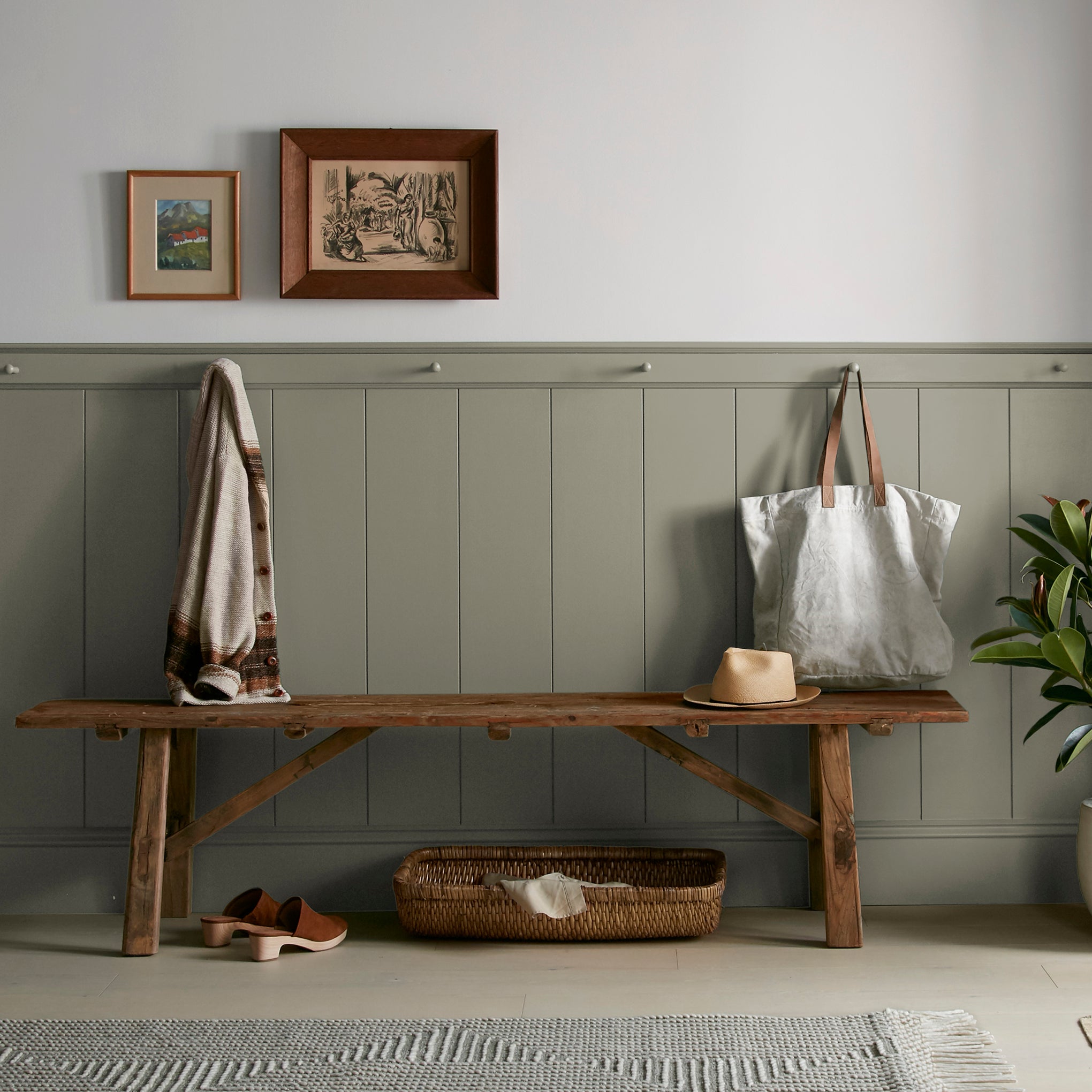 Lighter shade of army green with notes of hazel interior paint named garden party shown painted on entryway wall