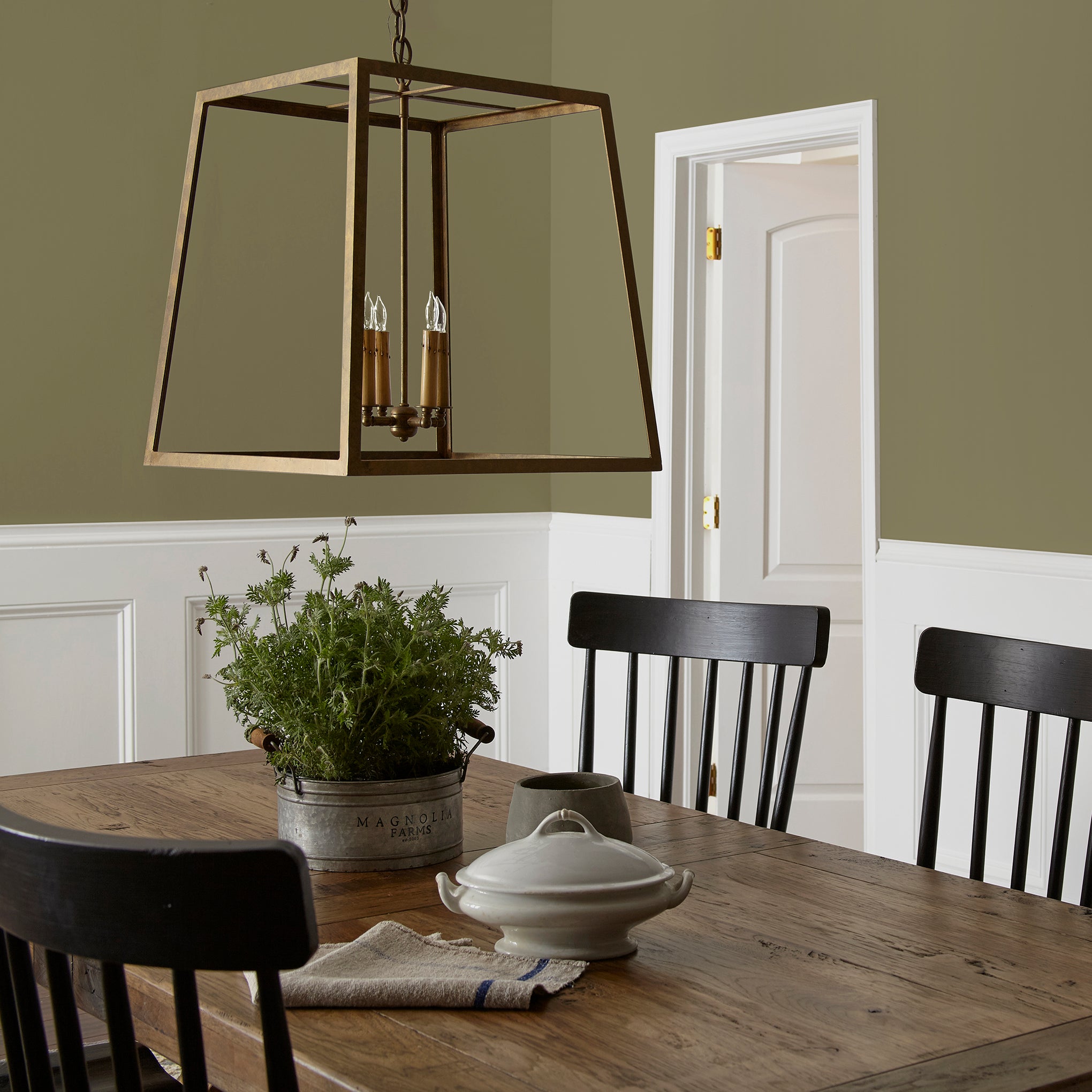 Asparagus green with hazel hues interior paint named landscape shown painted on dining room wall