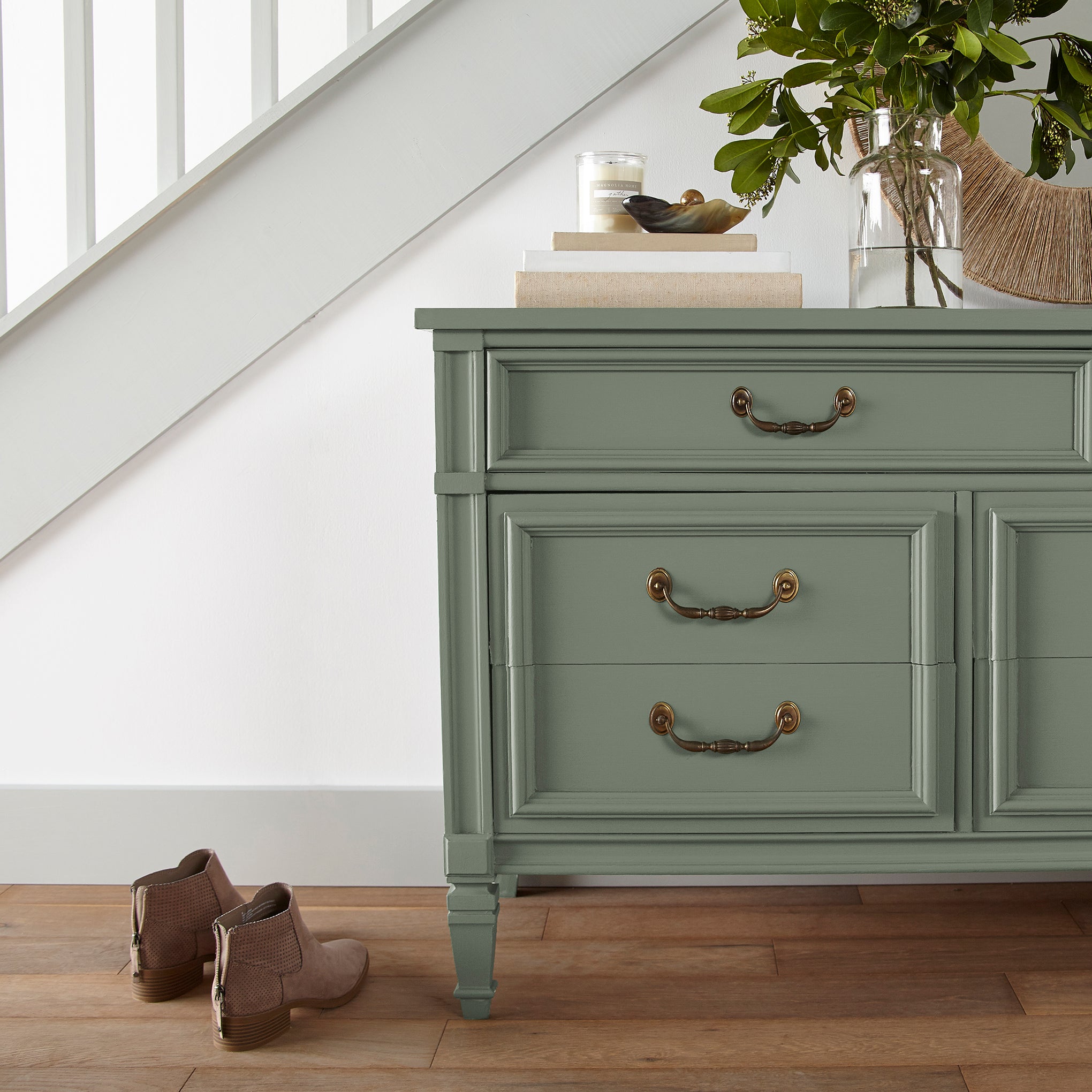 Earthy green with natural hints of hazel door and cabinet paint named olive grove shown painted on entryway cabinet