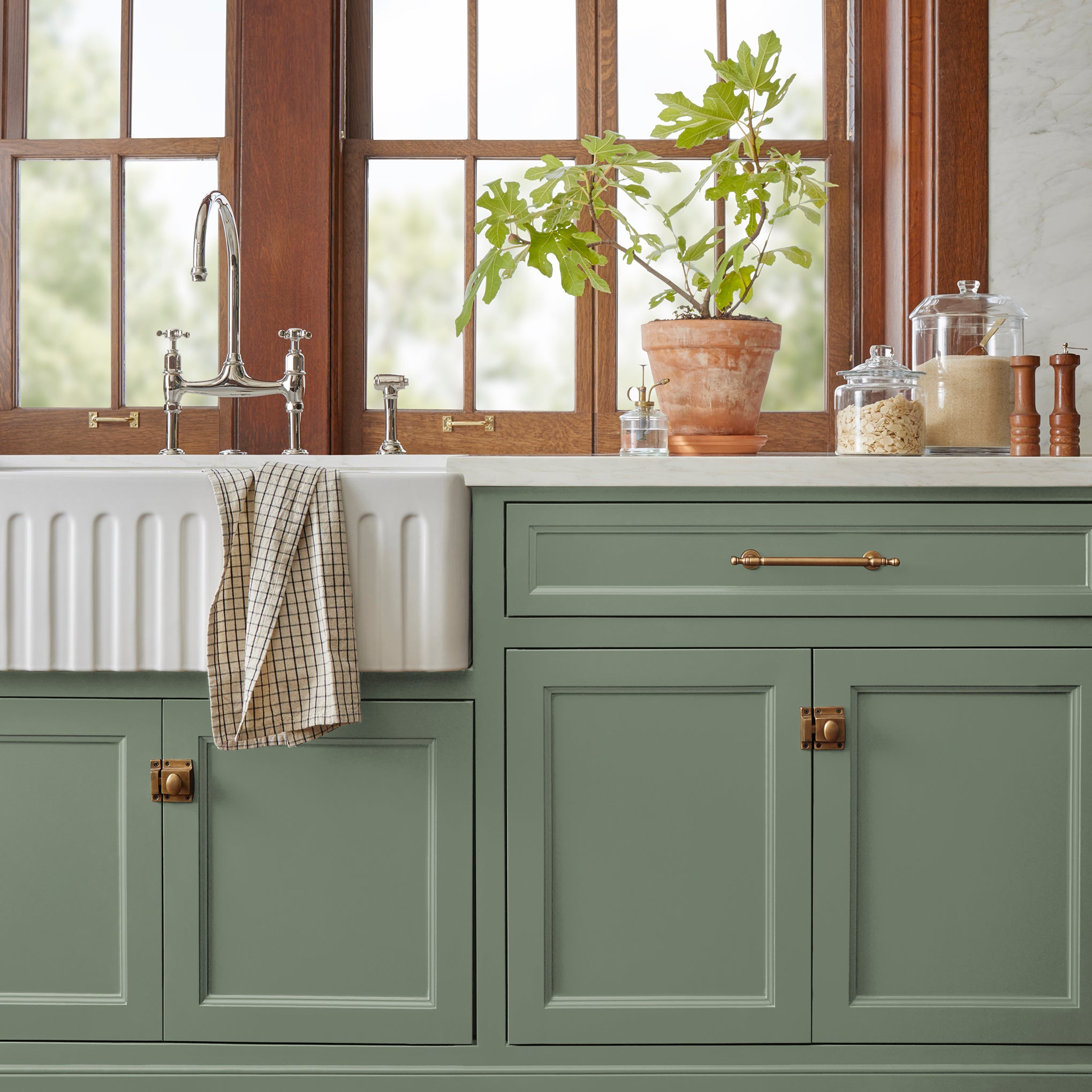 Earthy green with natural hints of hazel door and cabinet paint named olive green shown painted on kitchen cabinet 