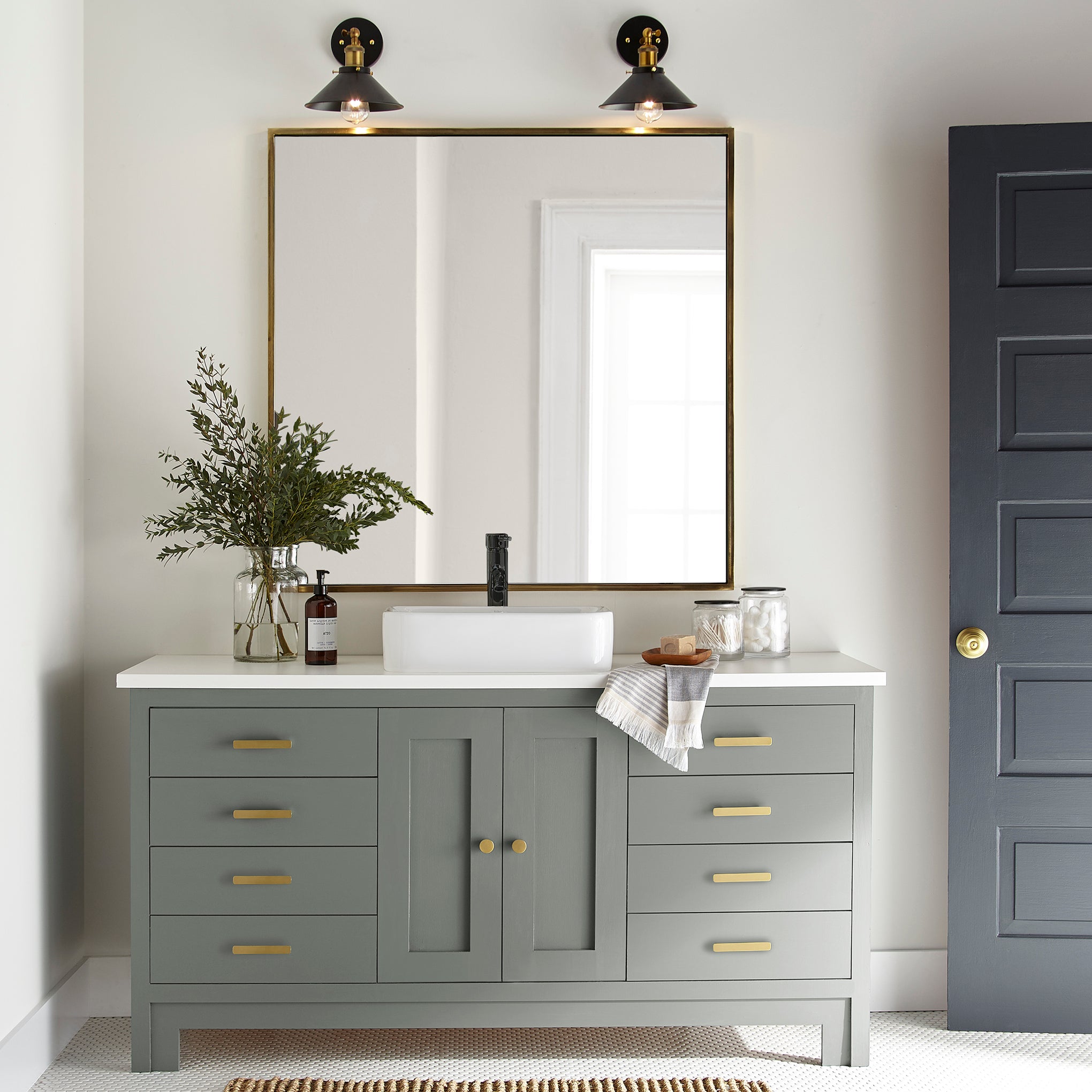 Mid-tone sage green blended with earthy gray door and cabinet paint named sage stem shown painted on bathroom cabinet