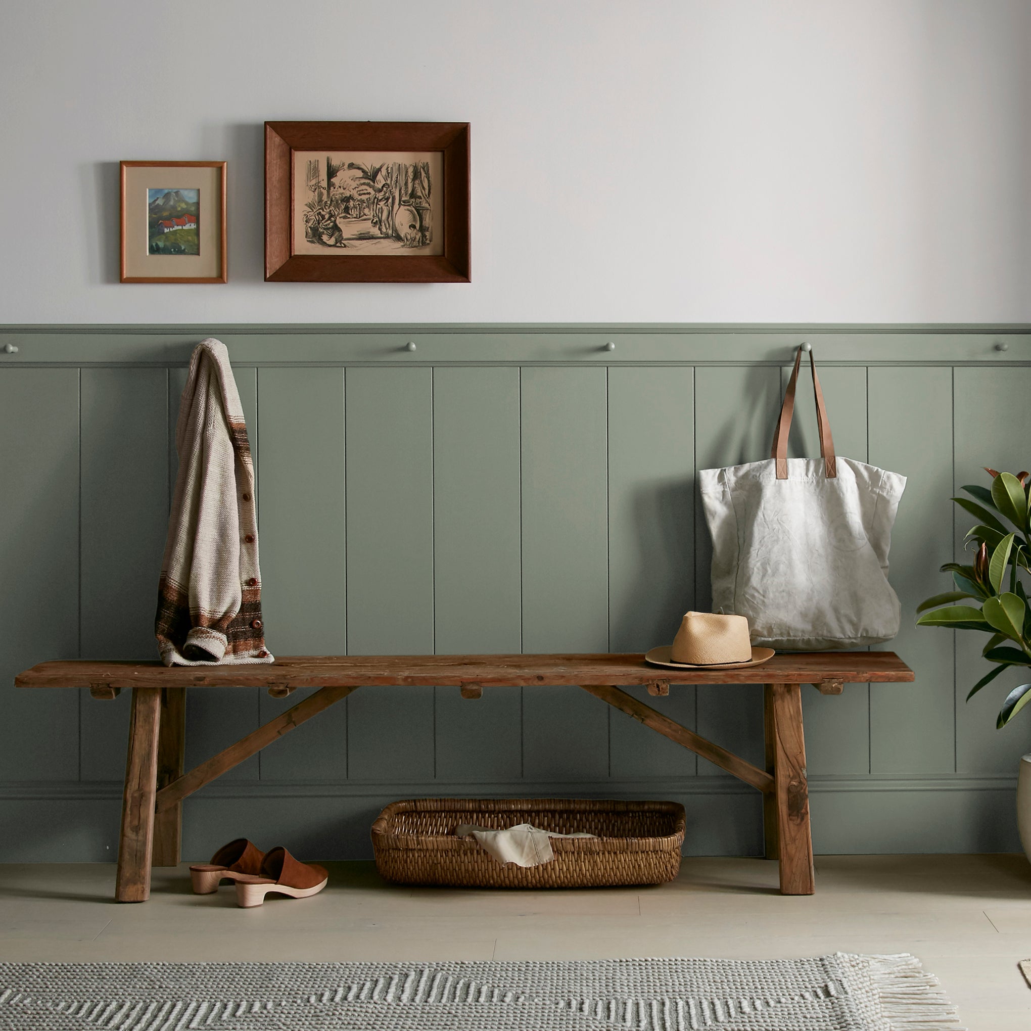 A dusty olive green interior paint named bespoke green shown painted on entryway wall