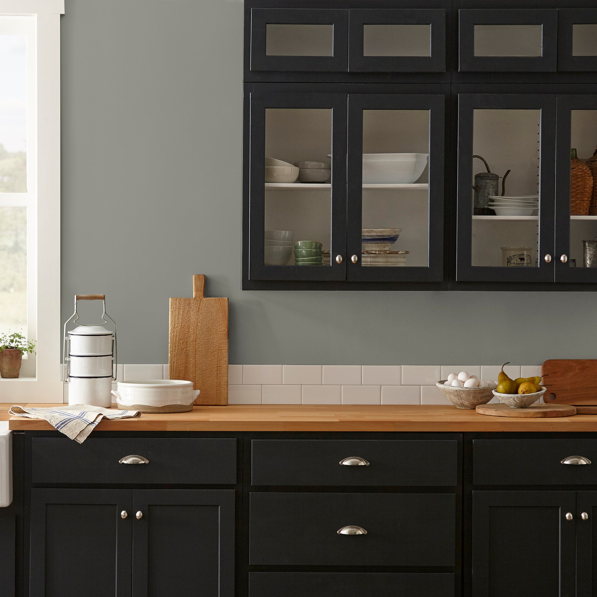dark gray with olive green undertone paint named boutique gray shown painted on kitchen wall