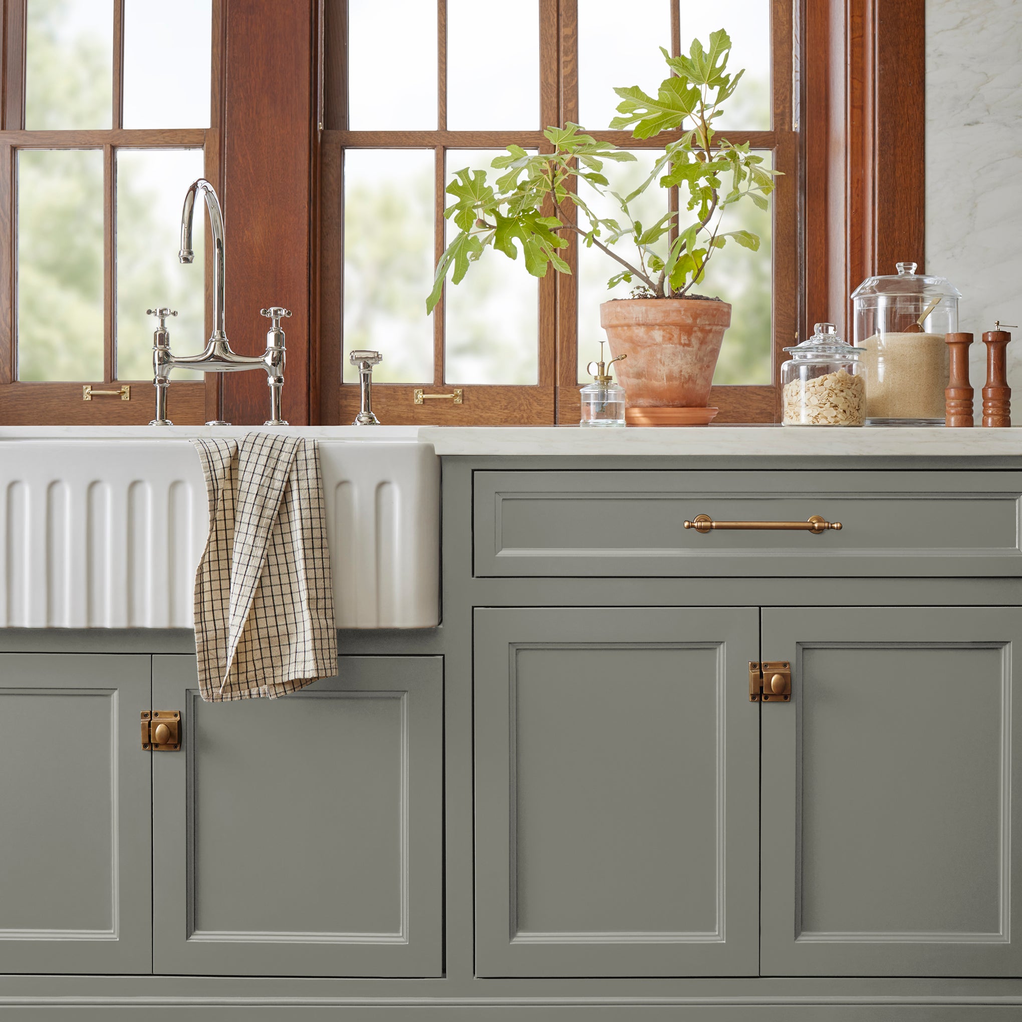 Gray with sage and olive green undertones door and cabinet paint named boutique gray shown painted on kitchen cabinet  
