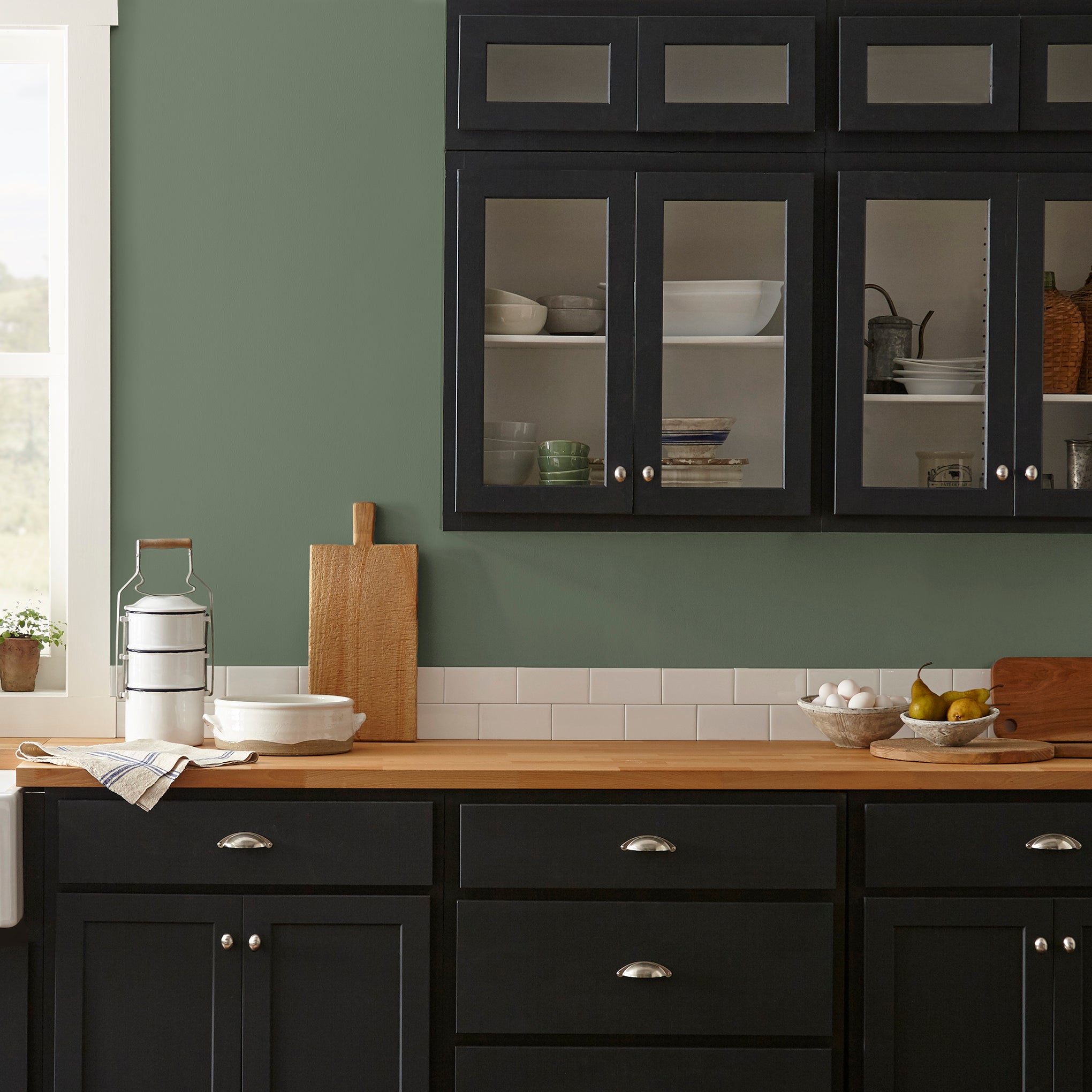 dark sage green paint named lemon leaves shown painted on kitchen wall
