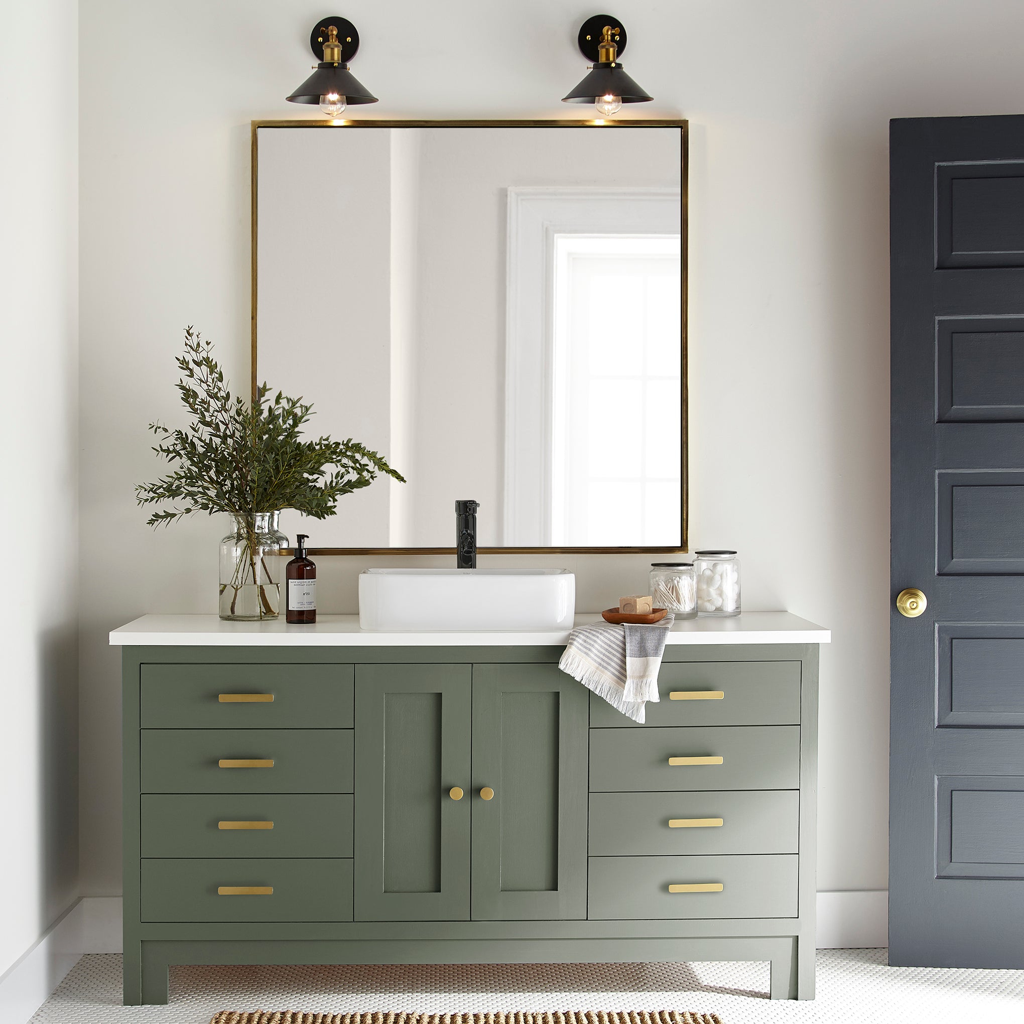 Dark and rich sage green door and cabinet paint named lemon leaves shown painted on bathroom cabinet