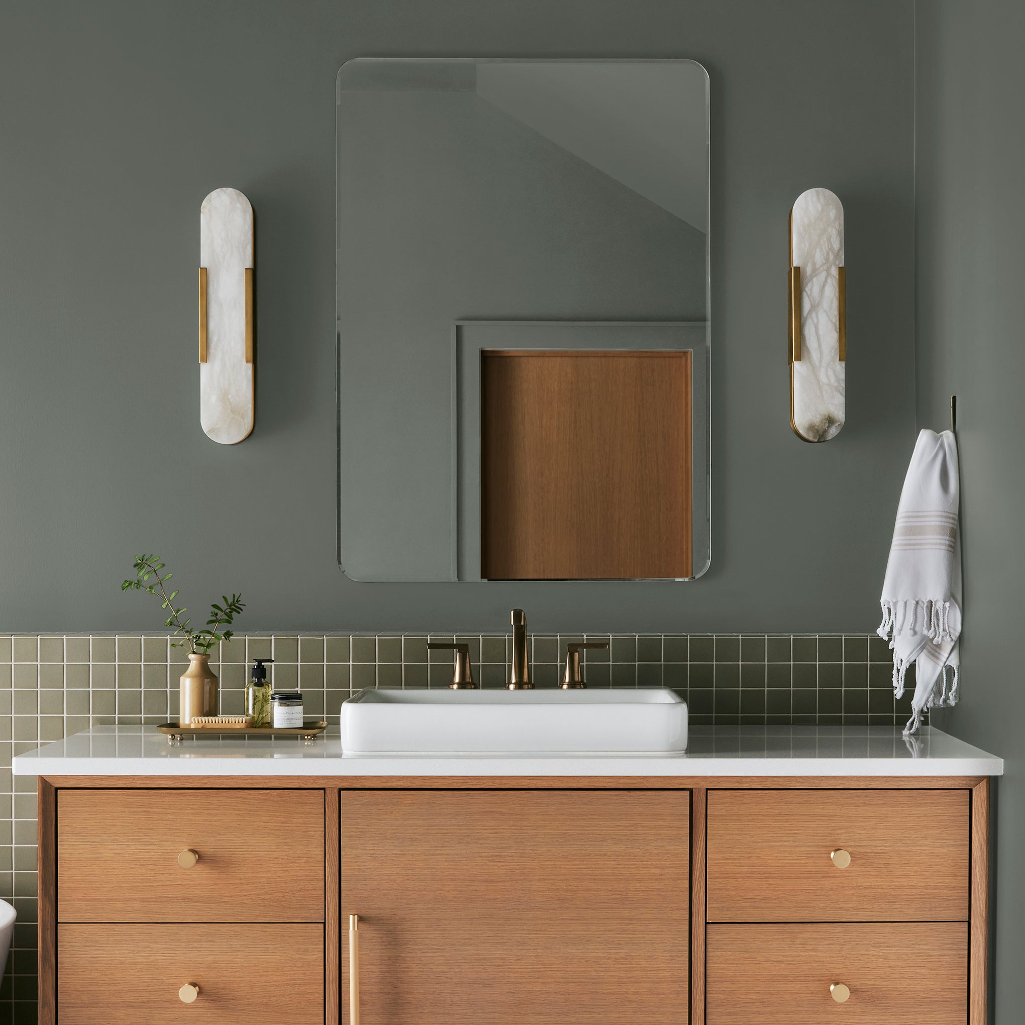 Army green with earthy brown and gray undertones interior paint named wellington green shown painted on bathroom wall