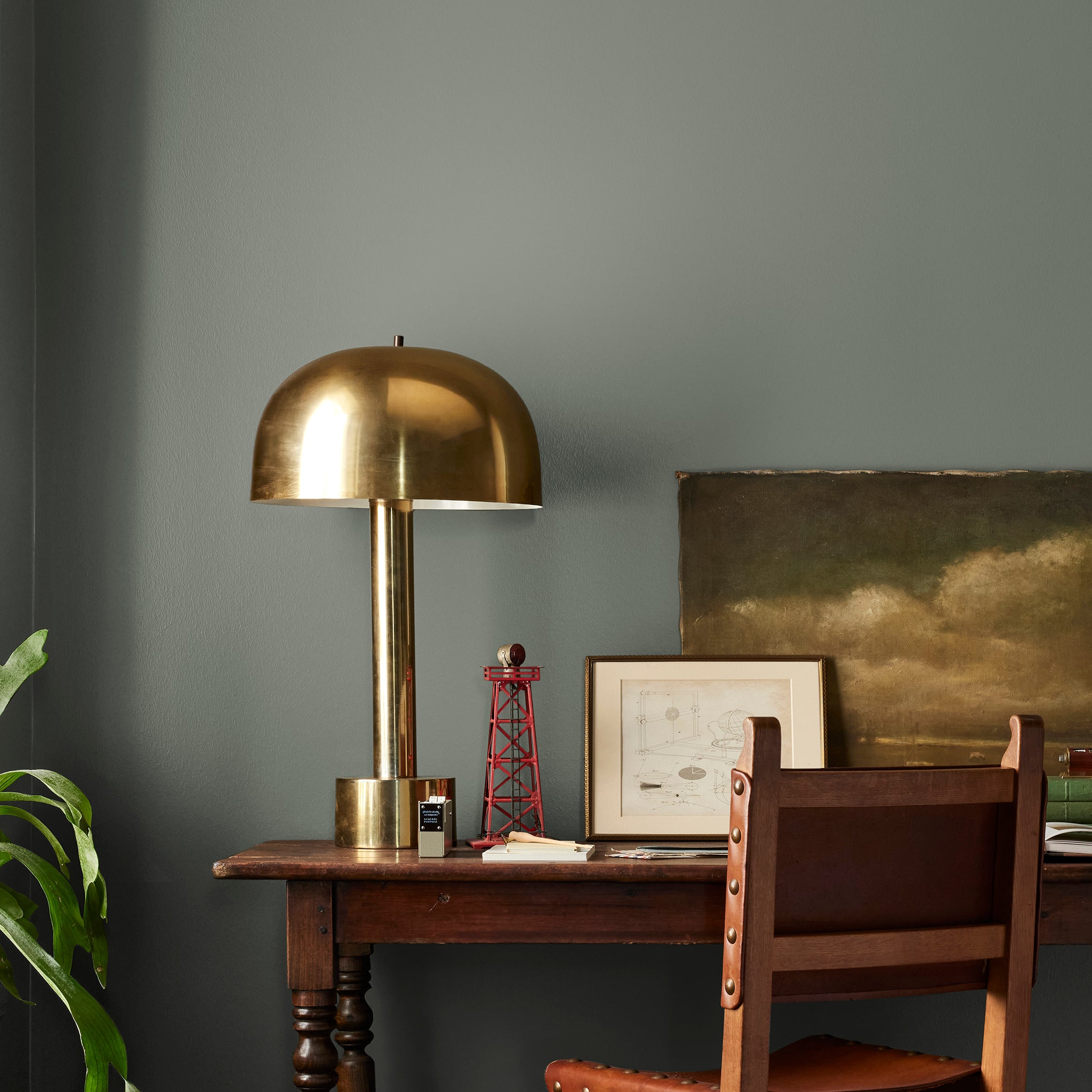 Army green with earthy brown and gray undertones interior paint named wellington green shown painted on bedroom wall