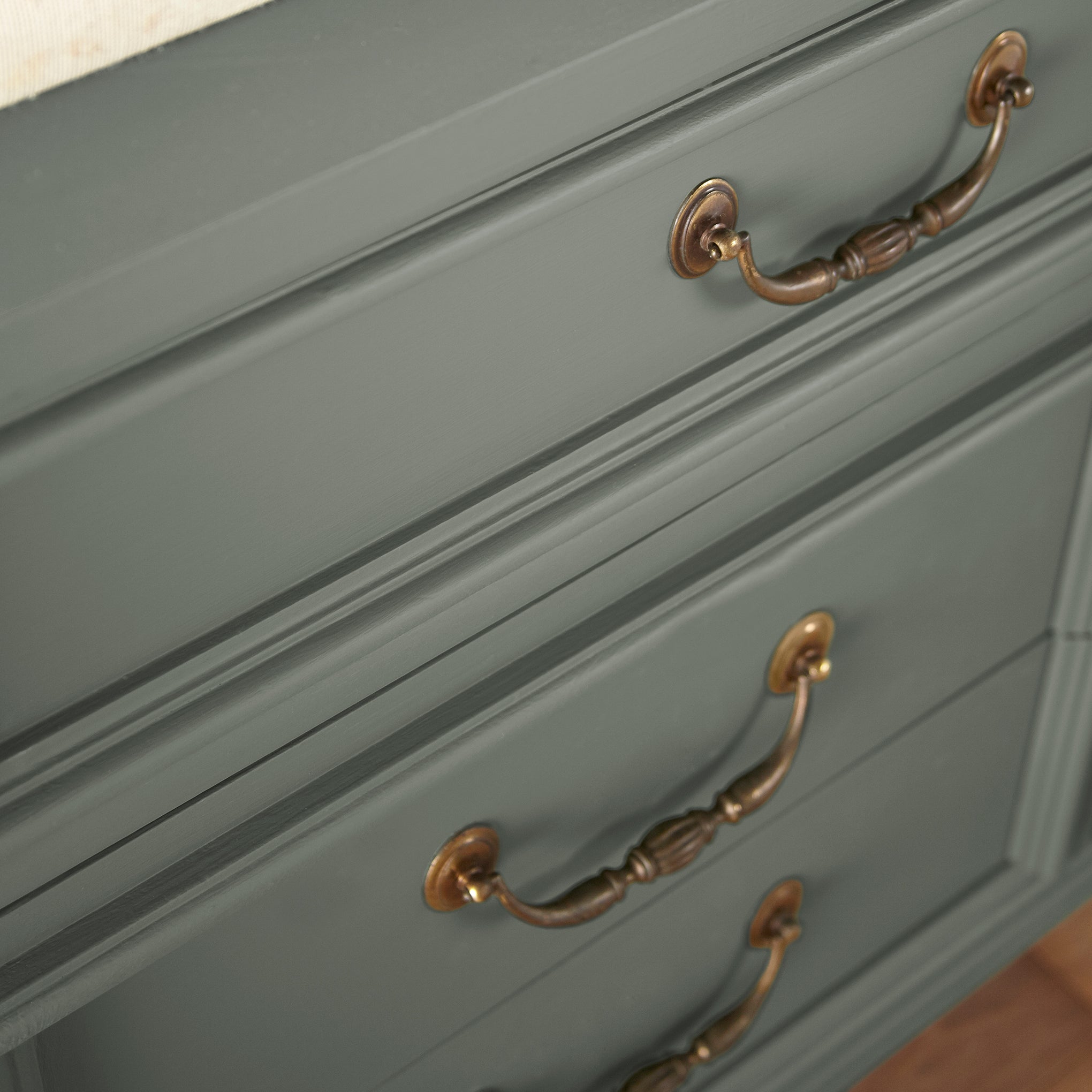 Almost army green with earthy brown and gray door and cabinet paint named wellington green shown painted on cabinet