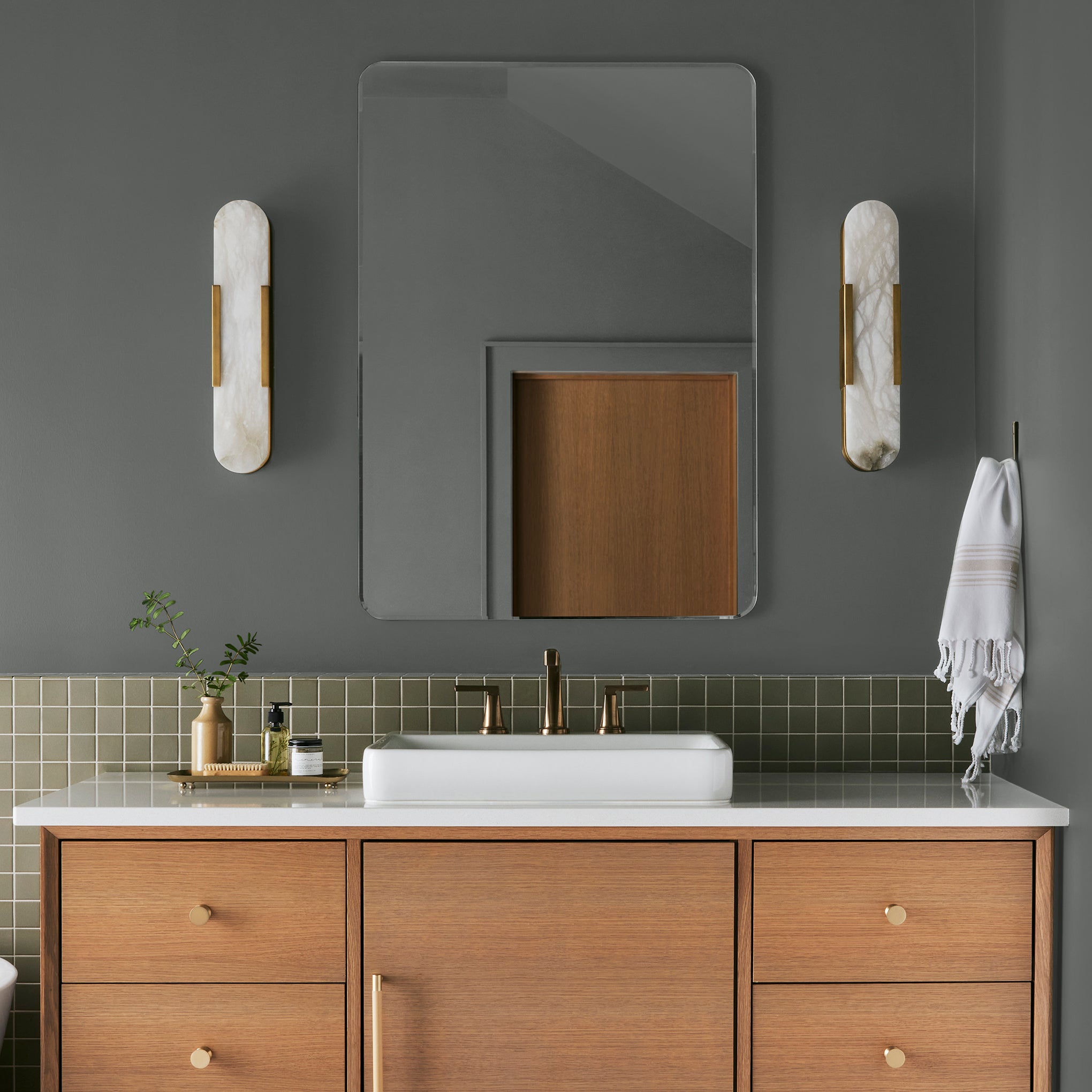 Deep haze gray with brown and silver notes interior paint named pond stone shown painted on bathroom wall