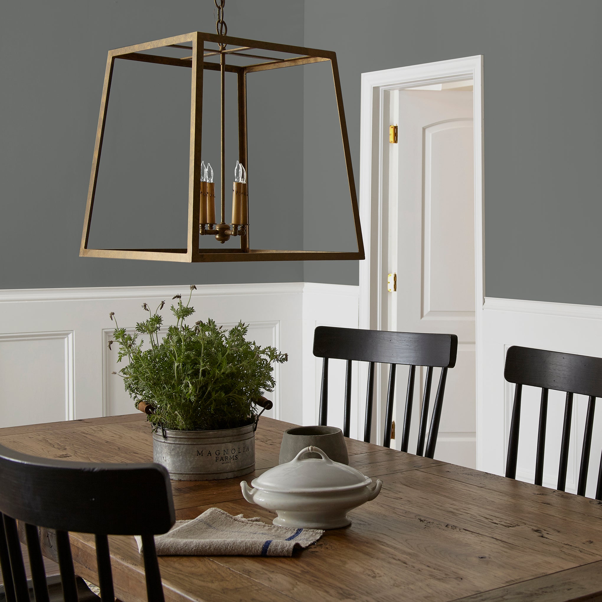 Deep haze gray with brown and silver notes interior paint named pond stone shown painted on dining room wall