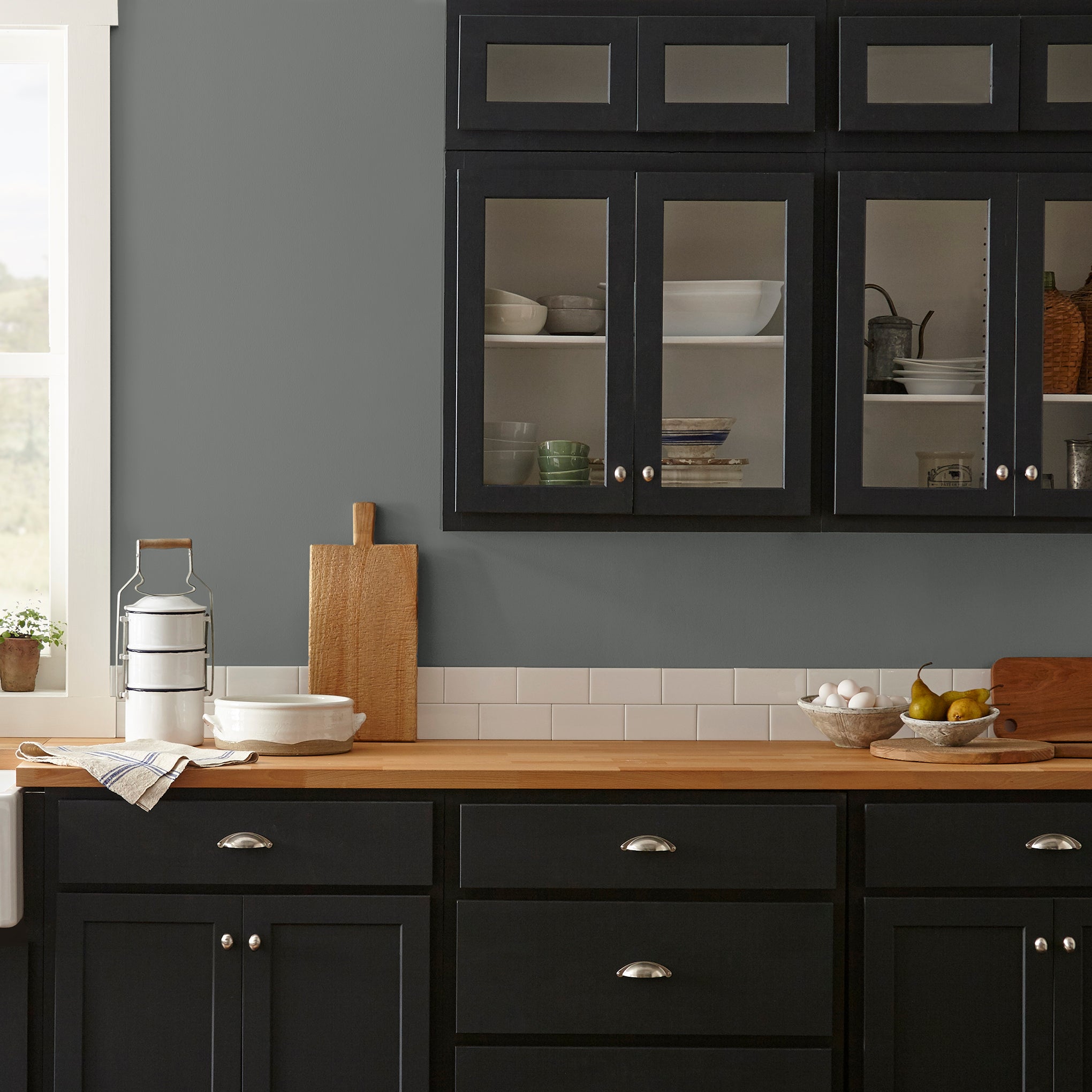 Deep haze gray with brown and silver notes interior paint named pond stone shown painted on kitchen wall