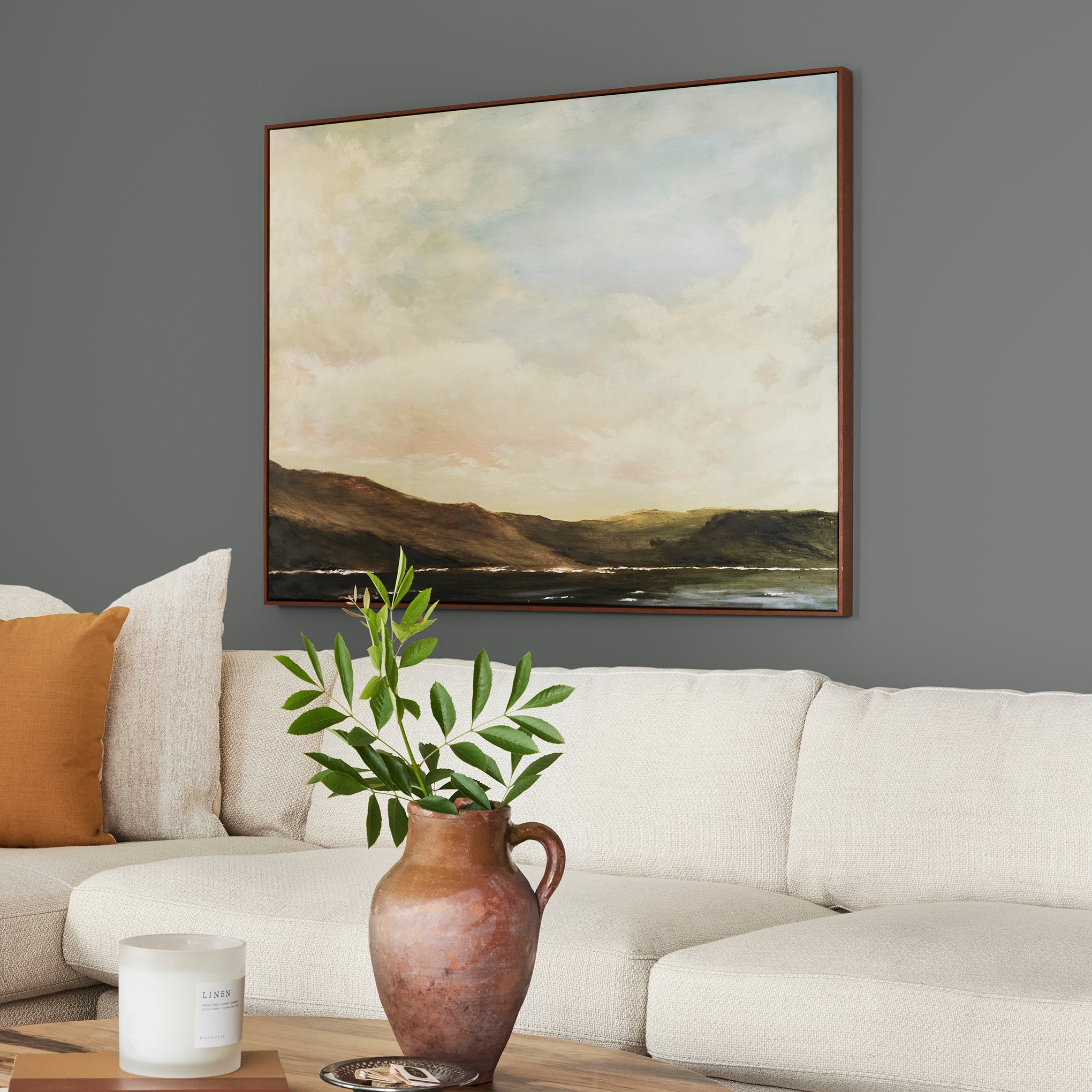 Deep haze gray with brown and silver notes interior paint named pond stone shown painted on living room wall