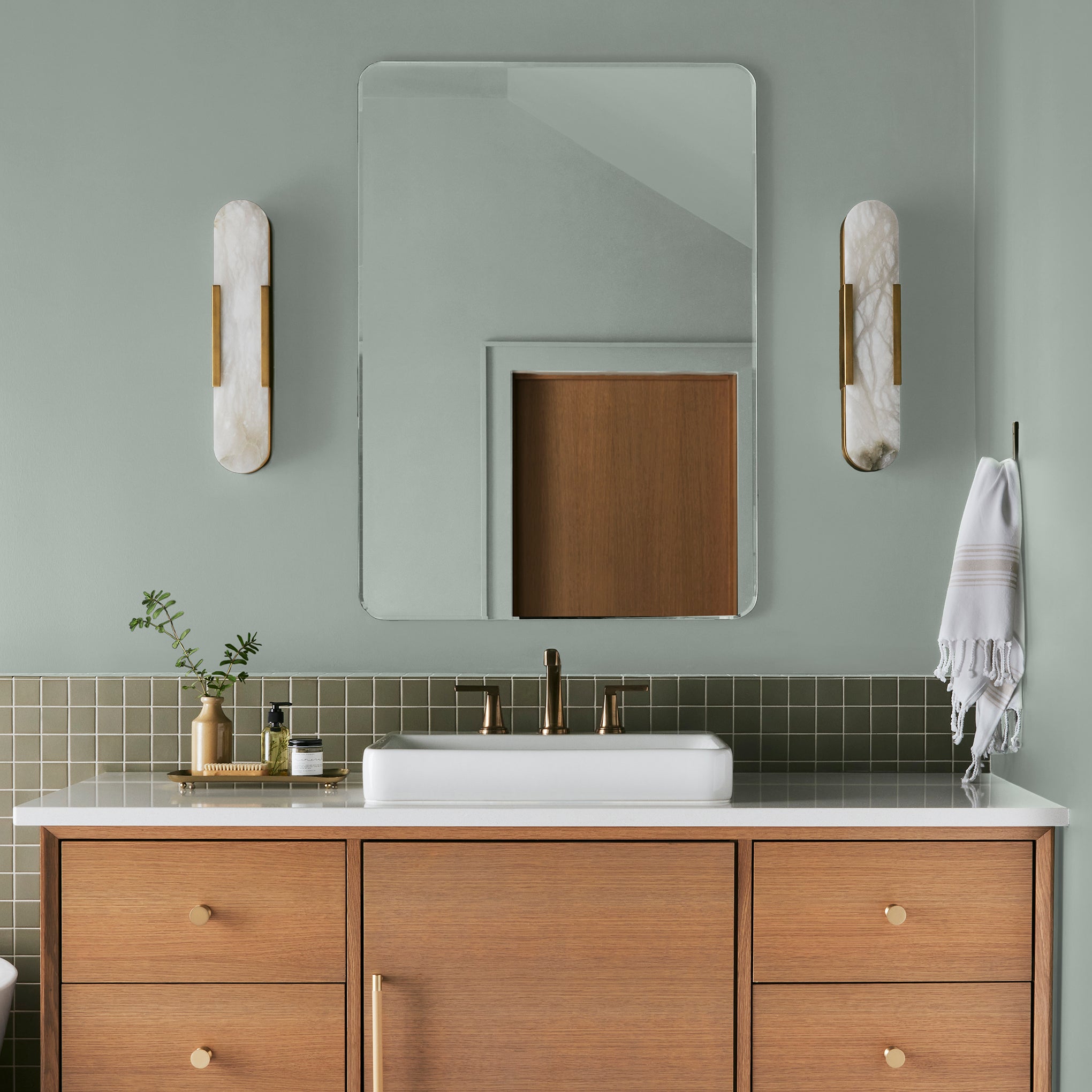 Frosty mint green with light blue undertone interior paint named mineral green shown painted on bathroom wall