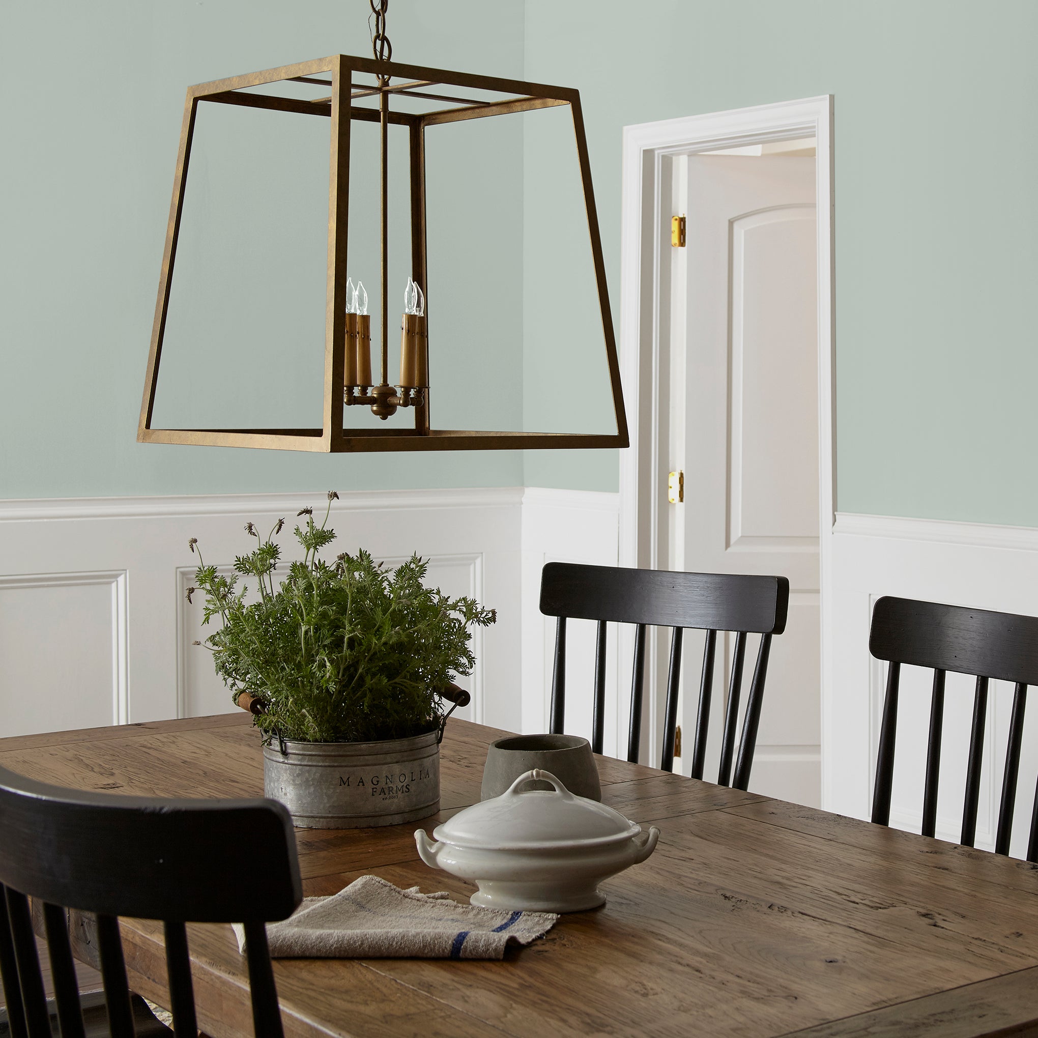 Frosty mint green with light blue undertone interior paint named mineral green shown painted on dining room wall