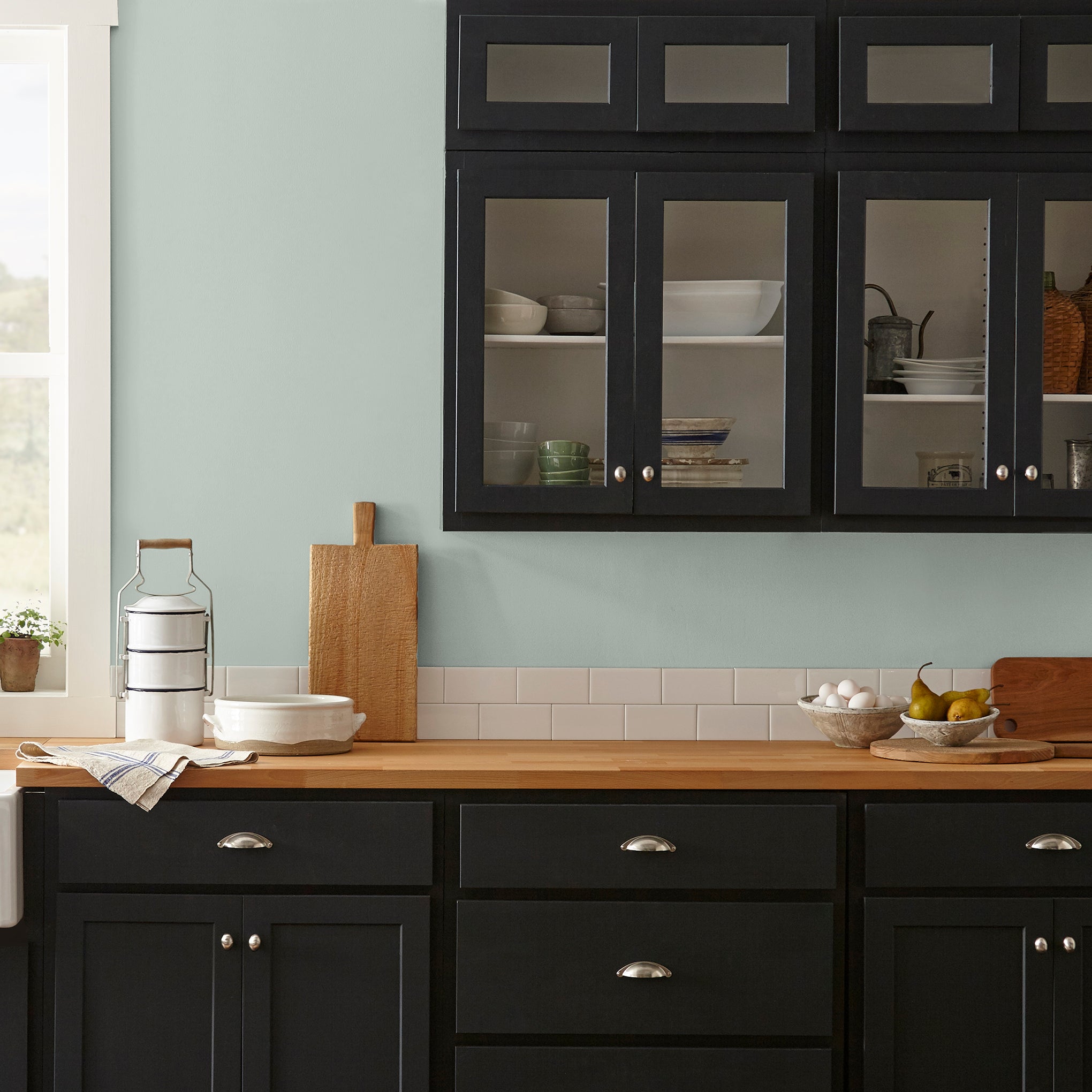 Frosty mint green with light blue undertone interior paint named mineral green shown painted on kitchen wall