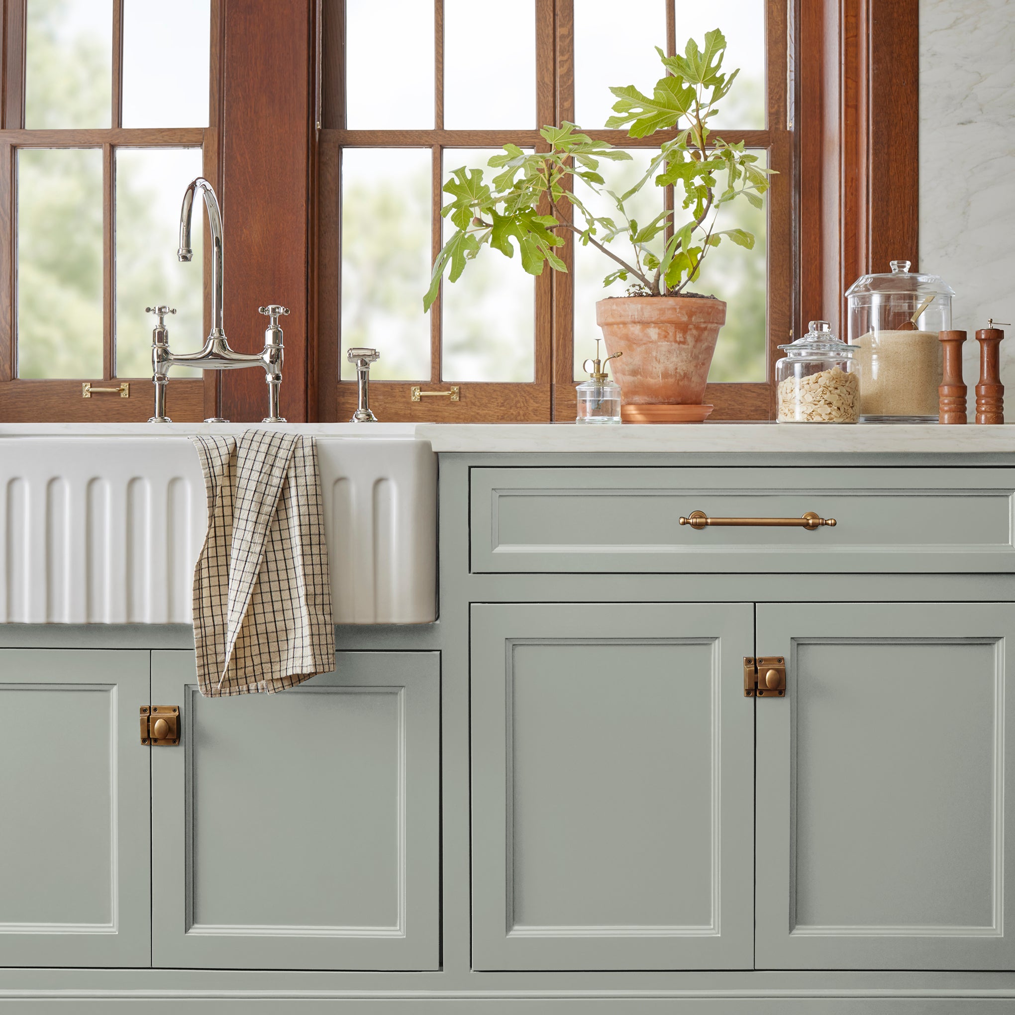 A light pale gray door and cabinet paint named early riser shown painted on kitchen cabinet  