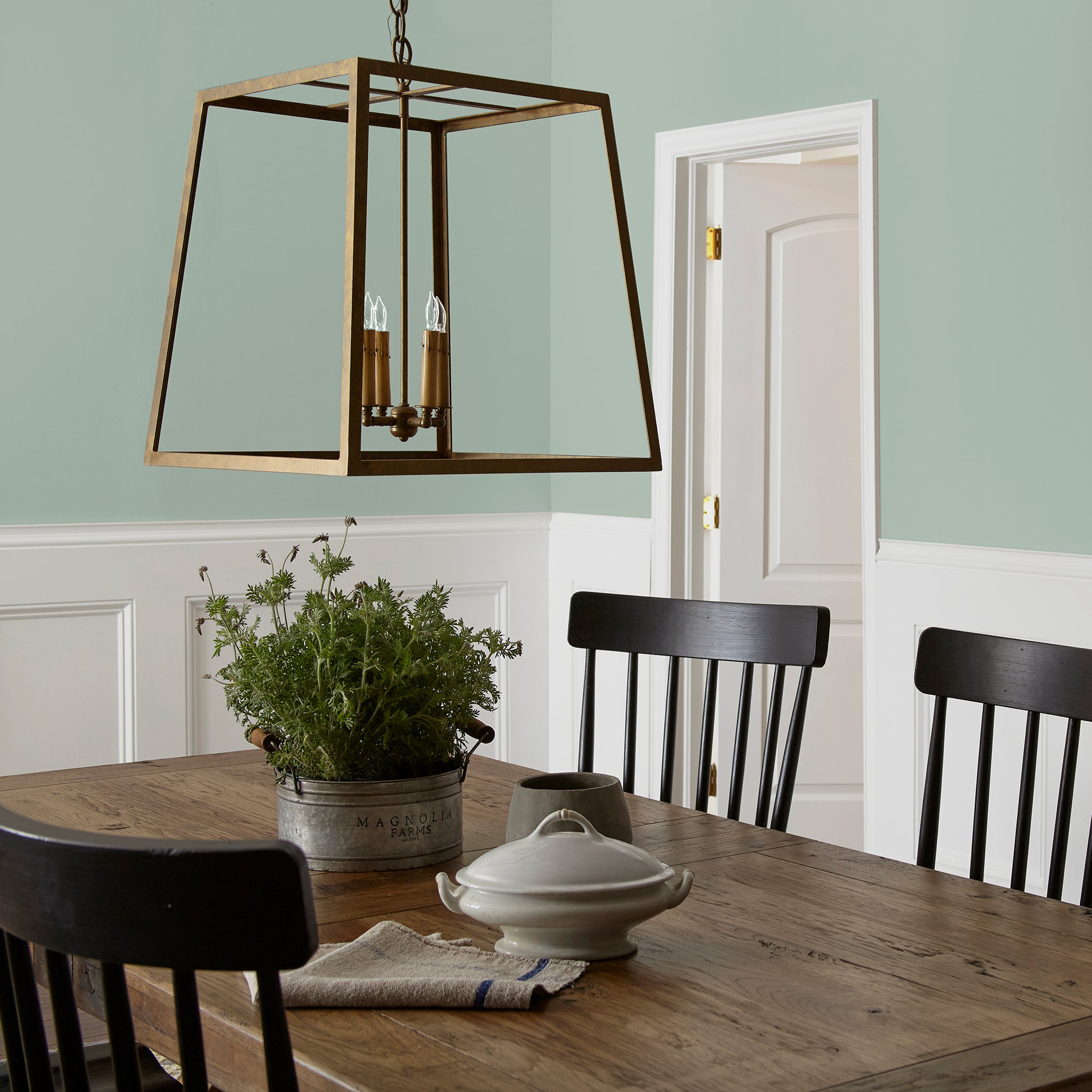 Creamy mint green interior paint named freshly cut stems shown painted on dining room wall