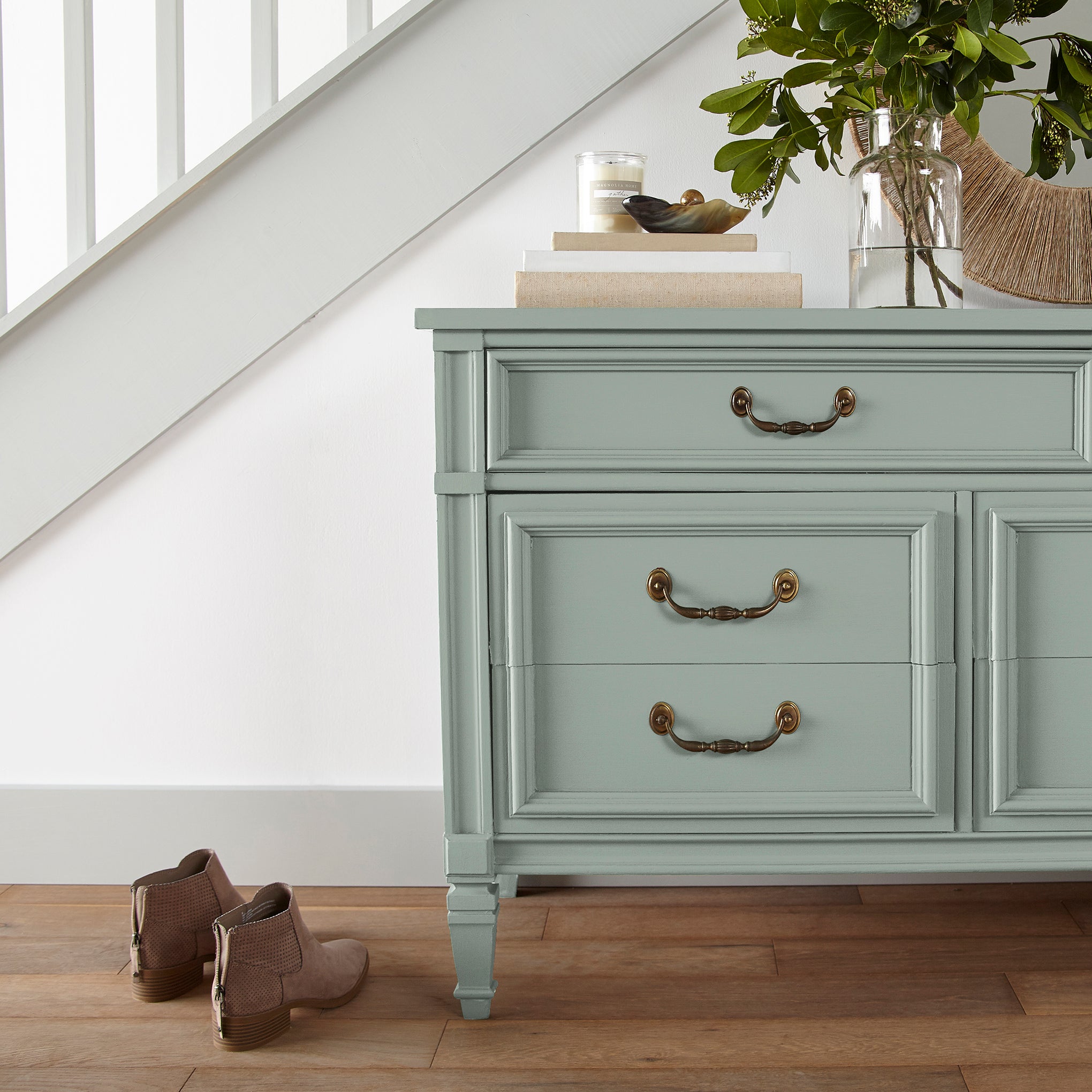 Creamy mint green door and cabinet paint named freshly cut stems shown painted on entryway cabinet