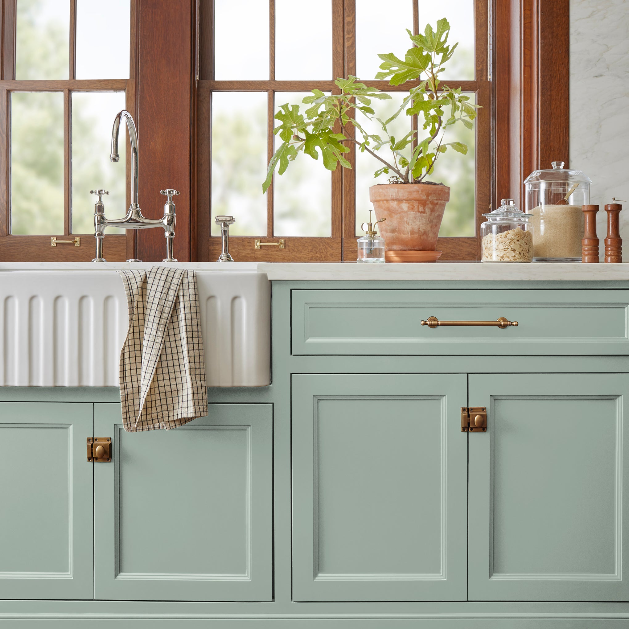Creamy mint green door and cabinet paint named freshly cut stems shown painted on kitchen cabinet  