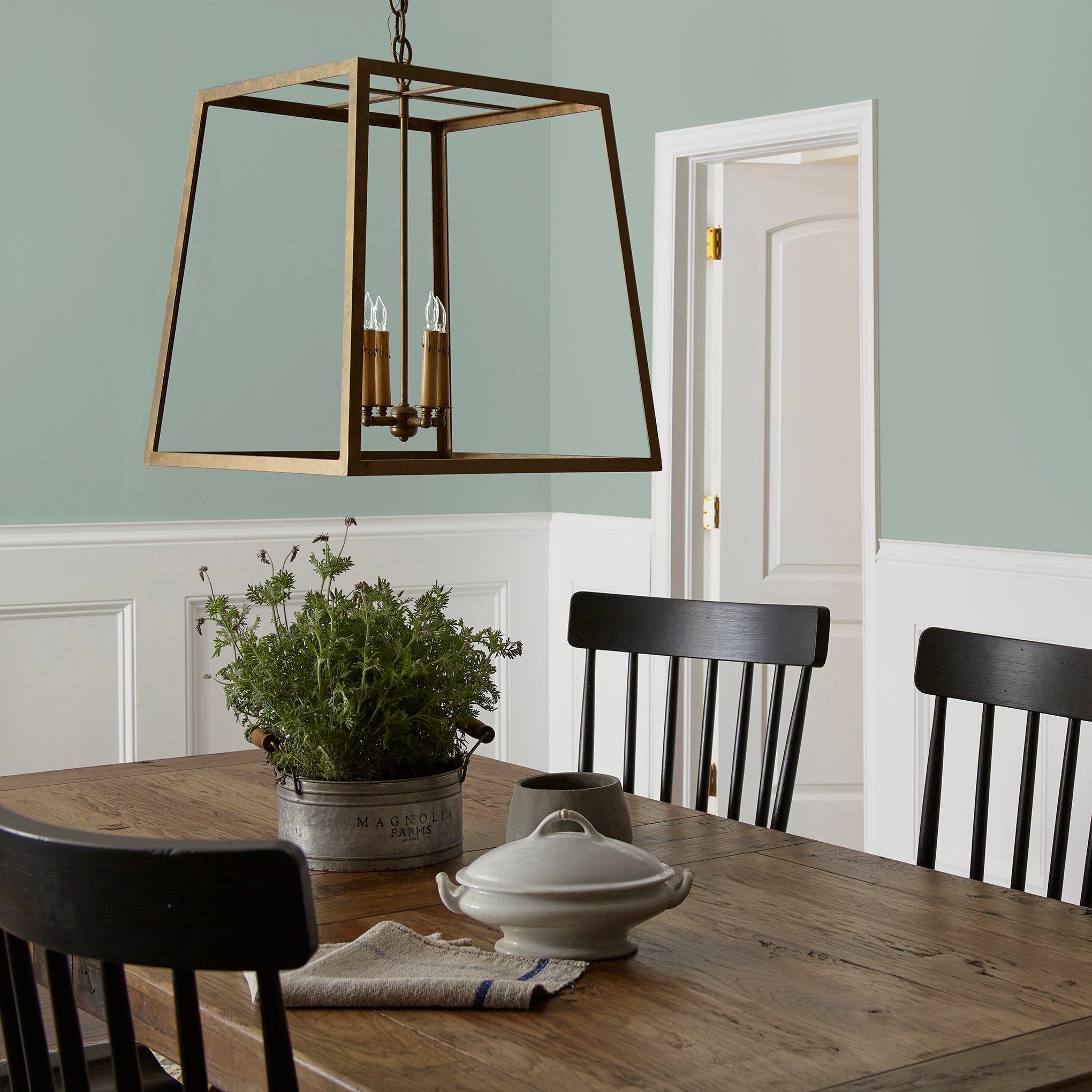 Washed mint green interior paint named local greenhouse shown painted on dining room wall