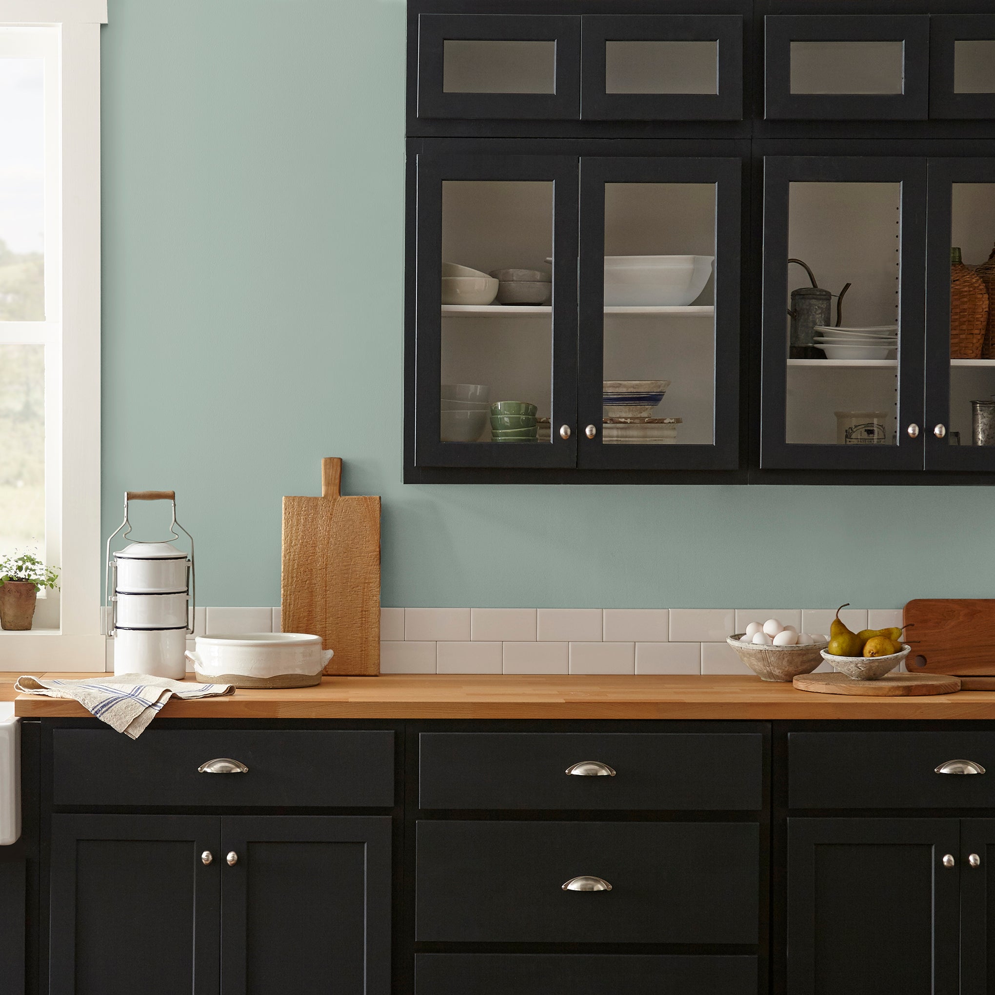 Washed mint green interior paint named local greenhouse shown painted on kitchen wall