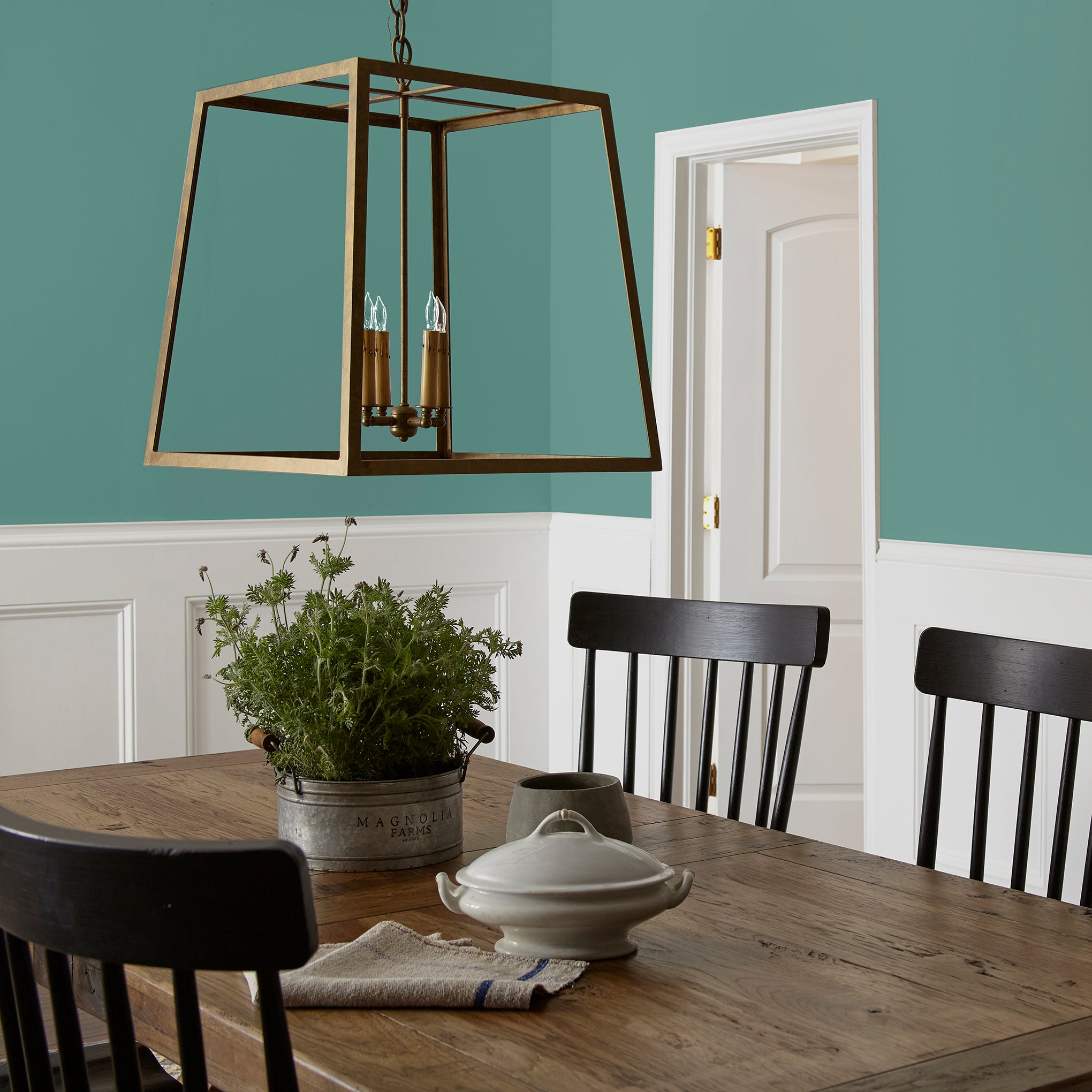 Dark aqua blue blended with a bit of ashy sage green interior paint named spontaneous shown painted on dining room wall
