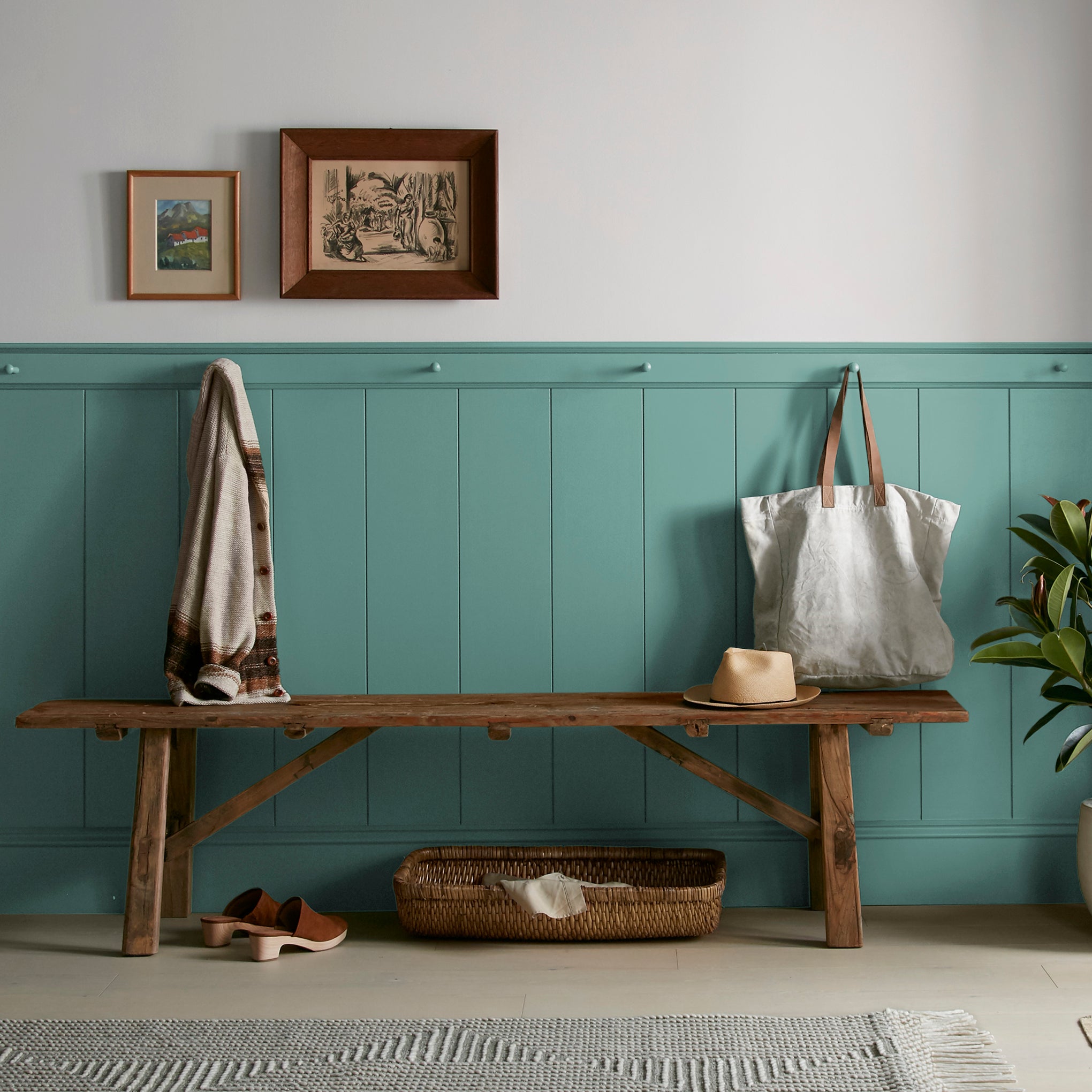 Dark aqua blue blended with a bit of ashy sage green interior paint named spontaneous shown painted on entryway wall