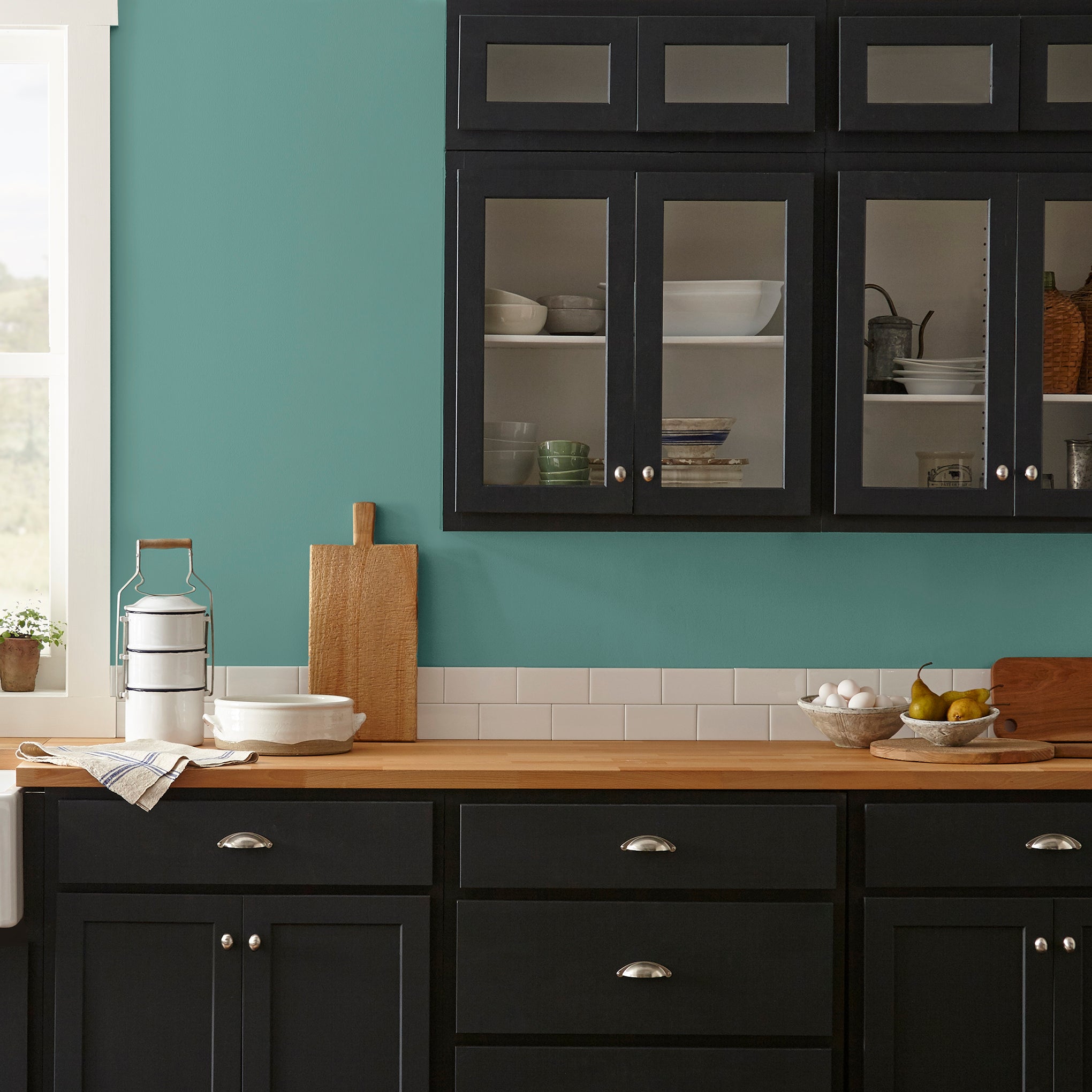 Dark aqua blue blended with a bit of ashy sage green interior paint named spontaneous shown painted on kitchen wall
