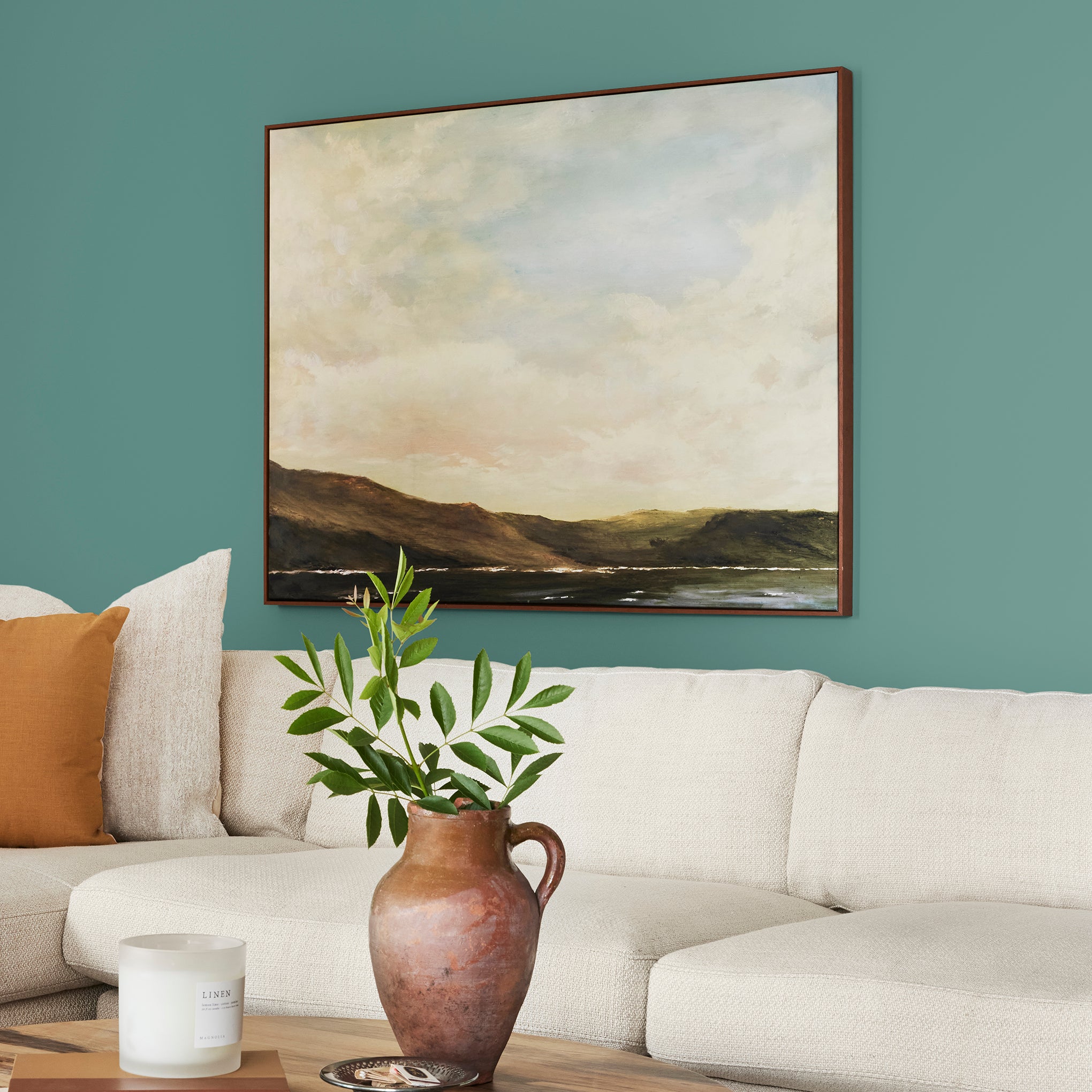 Dark aqua blue blended with a bit of ashy sage green interior paint named spontaneous shown painted on living room wall