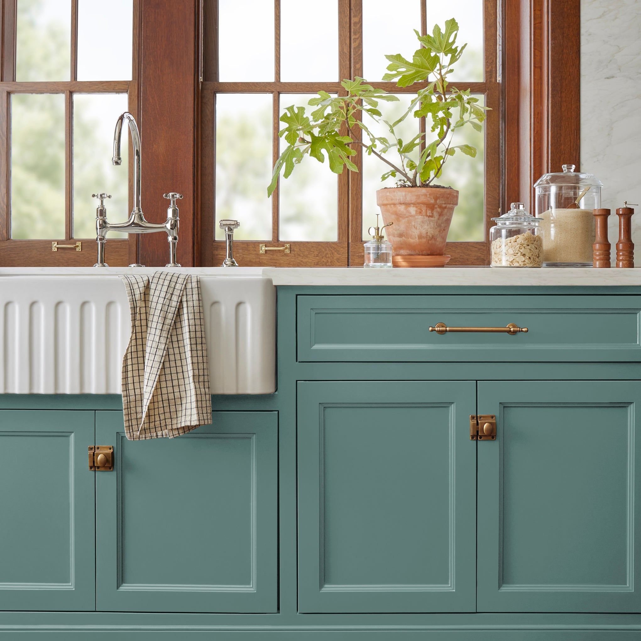 A dark, dusty aqua door and cabinet paint named tranquility shown painted on kitchen cabinet  