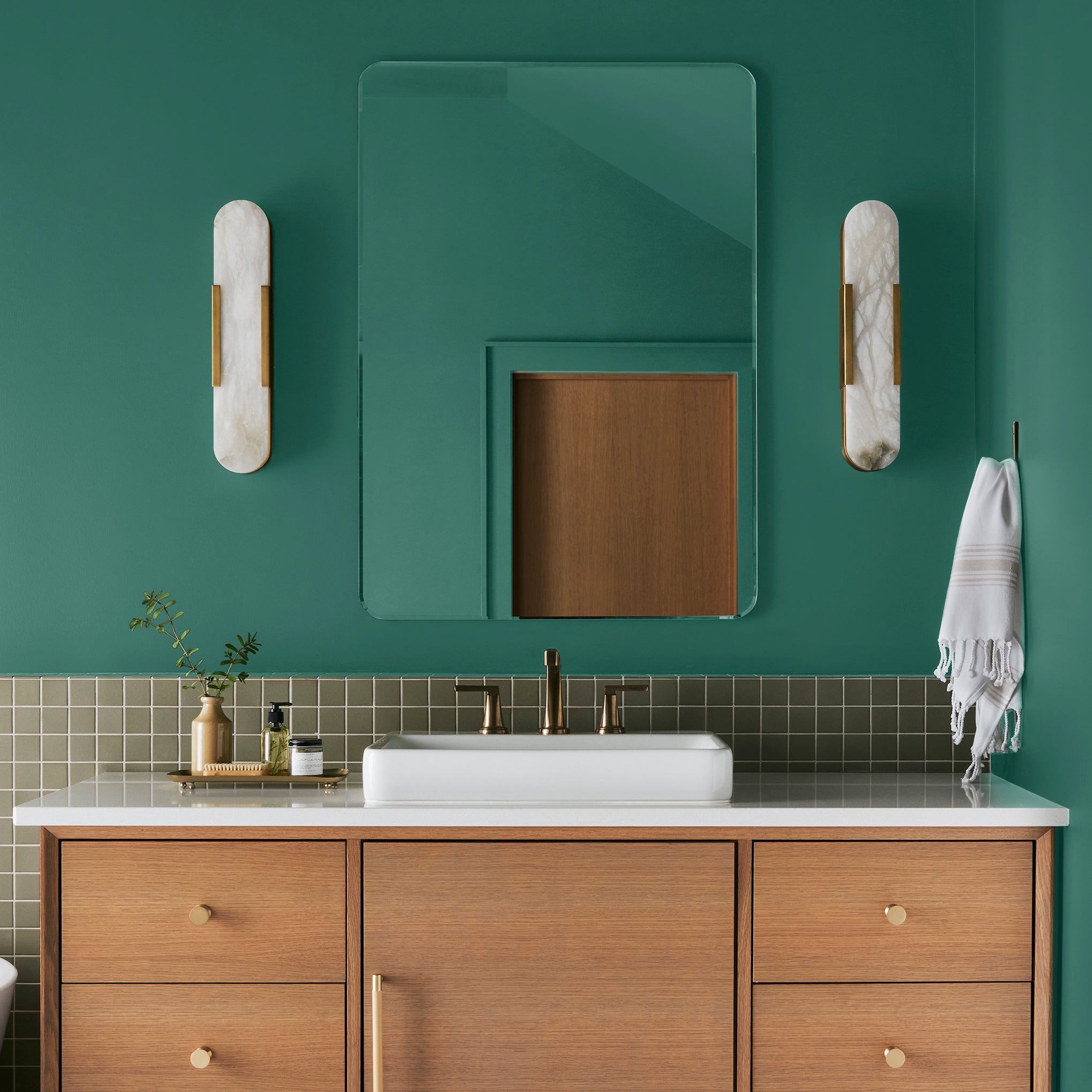 crisp hunter green with golden accents paint named aspen leaf shown painted on bathroom wall