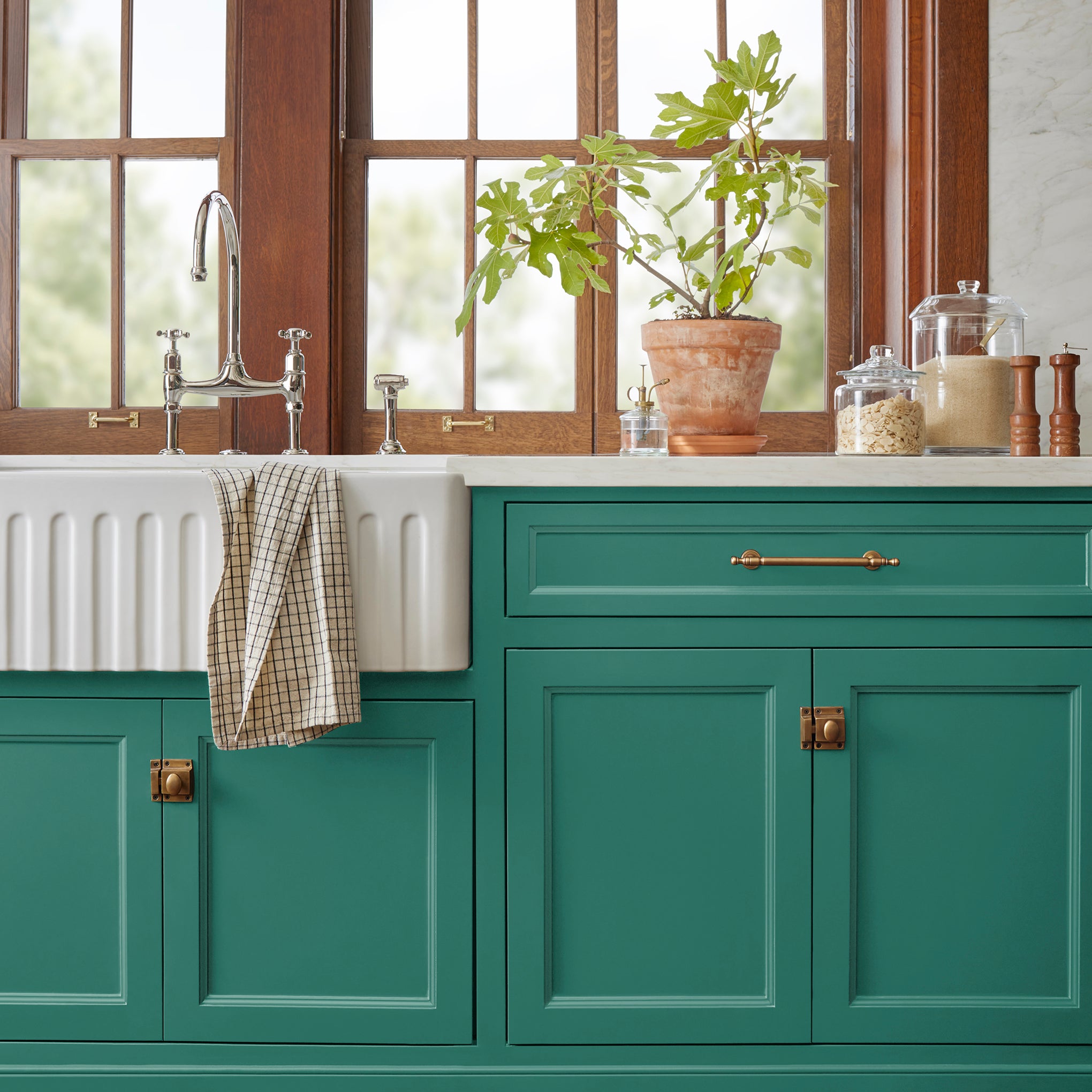 Crisp hunter green with golden accents door and cabinet paint named aspen leaf shown painted on kitchen cabinet  
