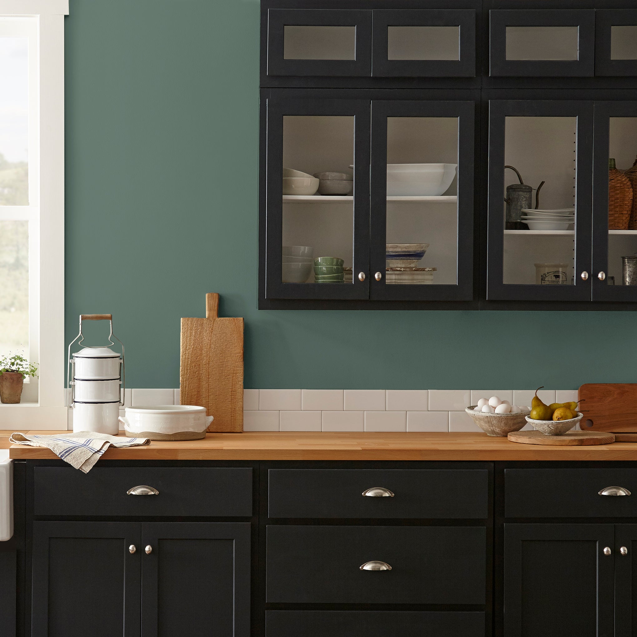 Deep hunter green interior paint named regal leaf shown painted on kitchen wall