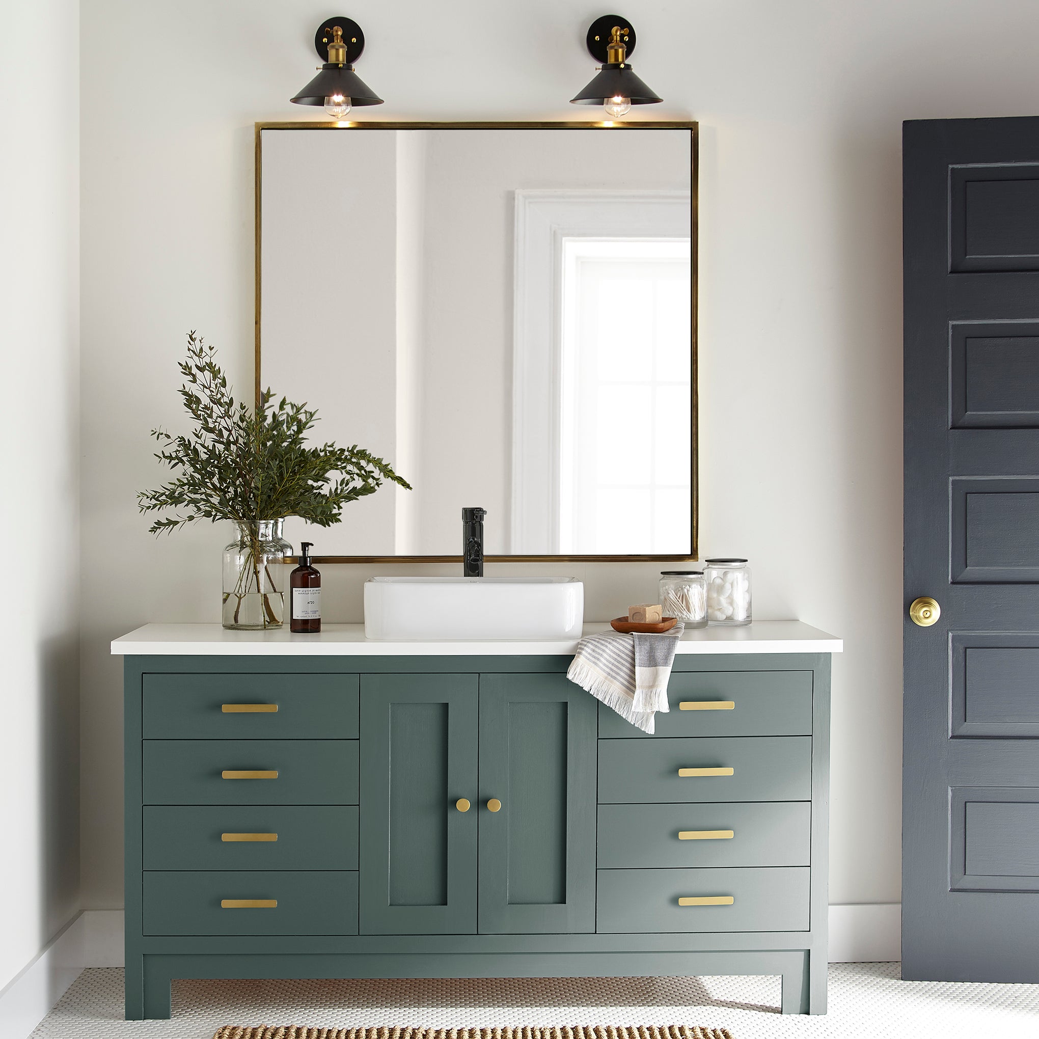 A slightly jeweled forest green hue door and cabinet paint named 1905 green shown painted on bathroom cabinet
