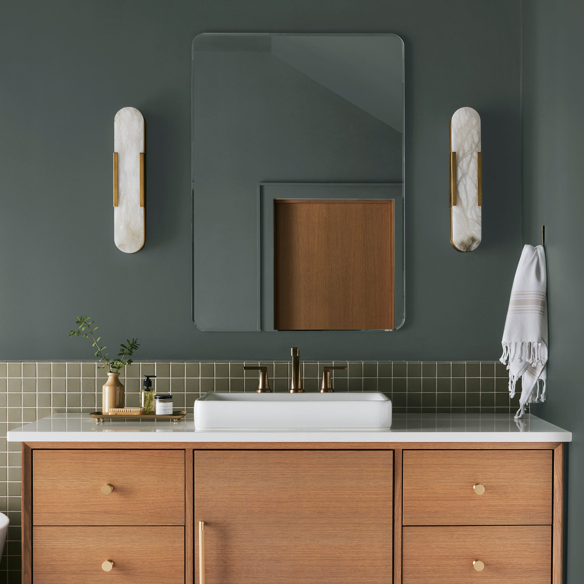 A slightly jeweled forest green hue classic interior paint named 1905 shown painted on bathroom wall