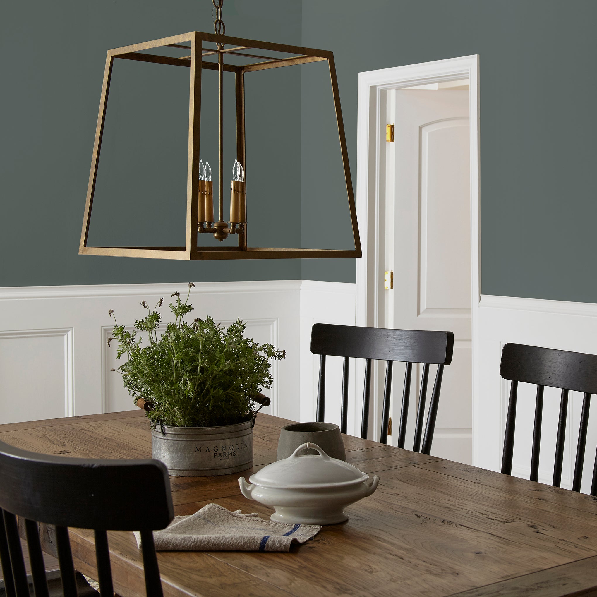 A slightly jeweled forest green hue classic interior paint named 1905 shown painted on dining room wall