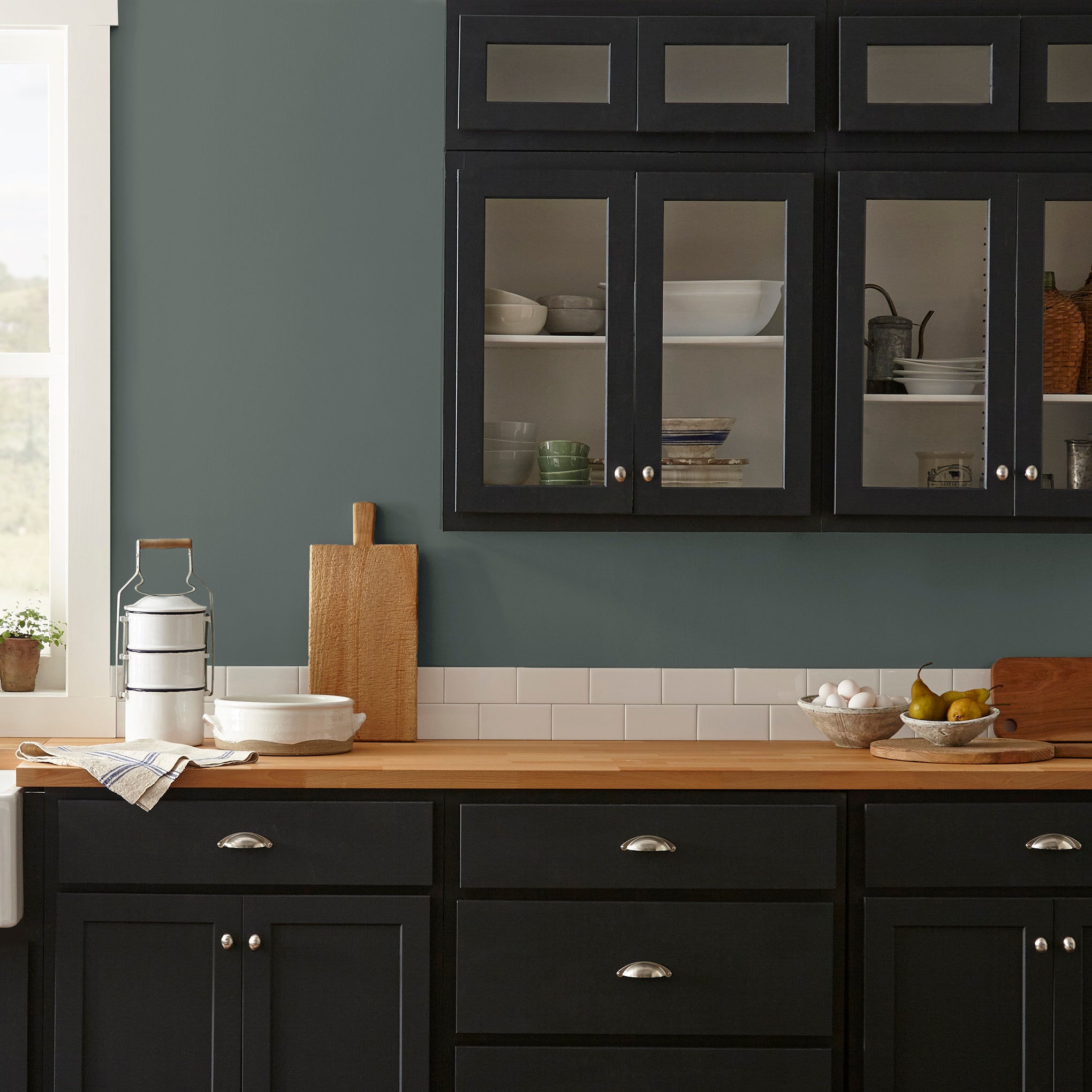 A slightly jeweled forest green hue classic interior paint named 1905 shown painted on kitchen wall