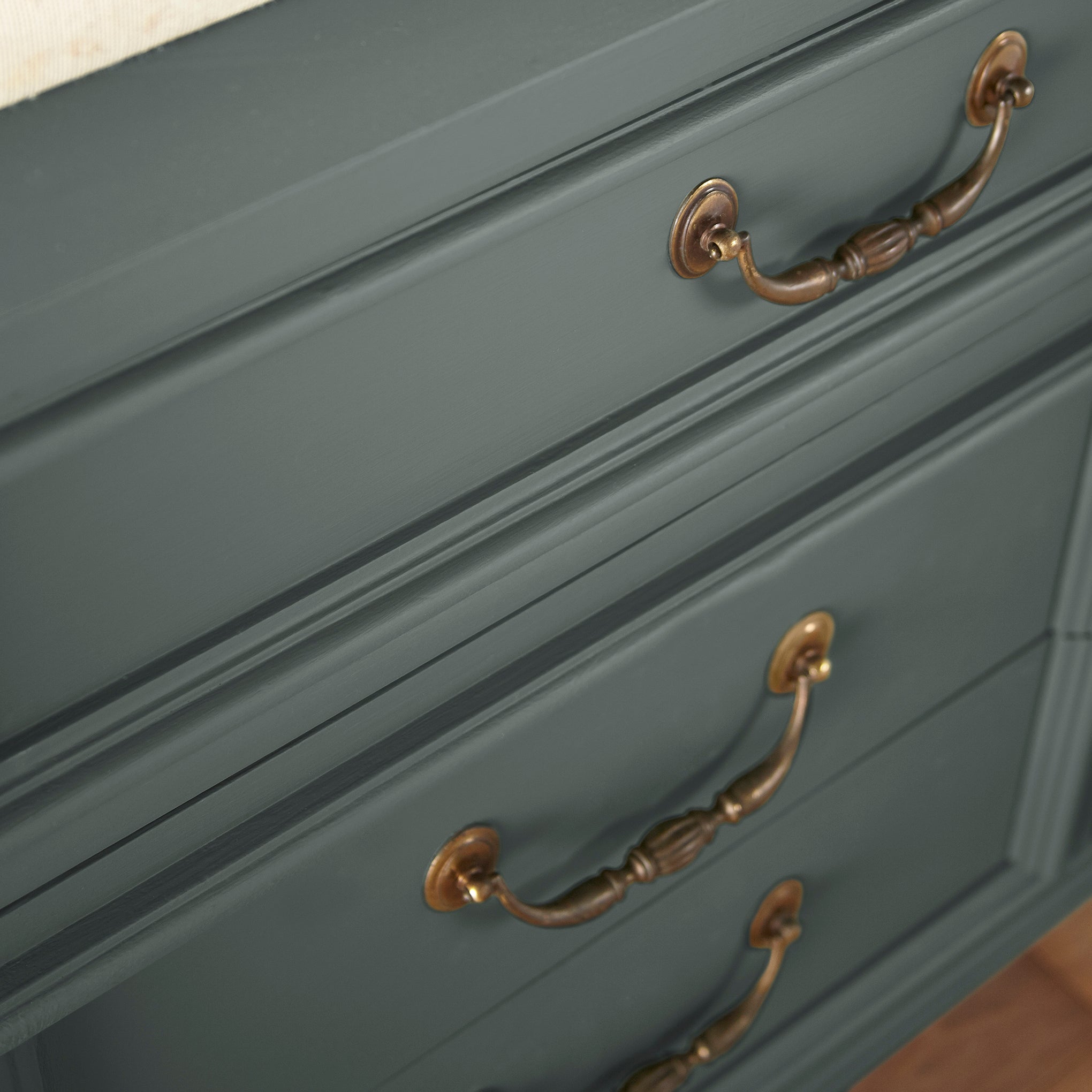 A slightly jeweled forest green hue door and cabinet paint named 1905 green shown painted on cabinet