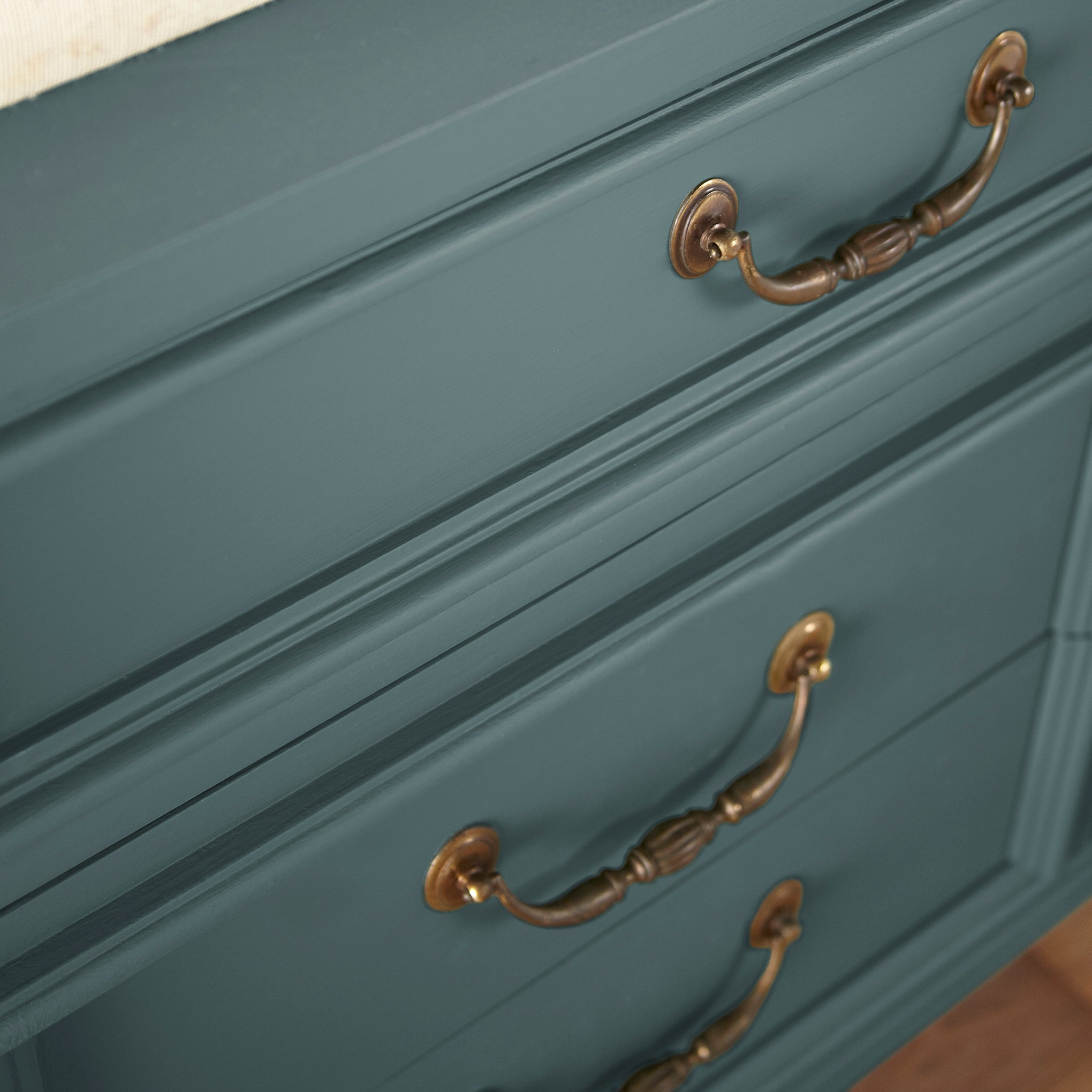 A muted peacock blue door and cabinet paint named secondhand find shown painted on cabinet