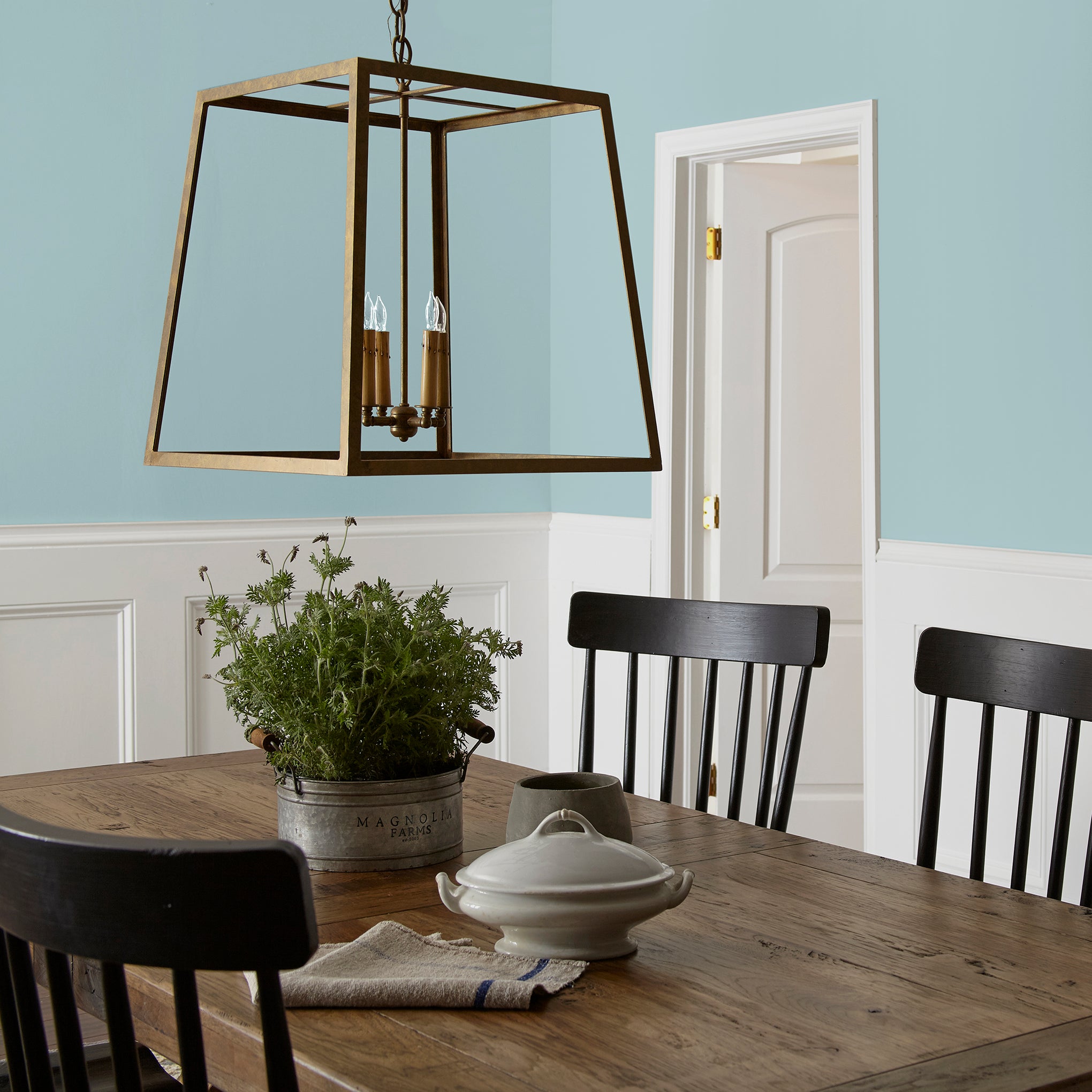 A muted blue interior paint named vibrant horizon shown painted on dining room wall
