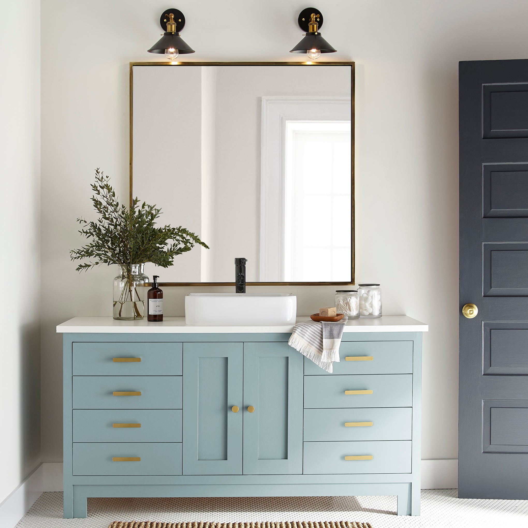 A muted blue door and cabinet paint named vibrant horizon shown painted on bathroom cabinet