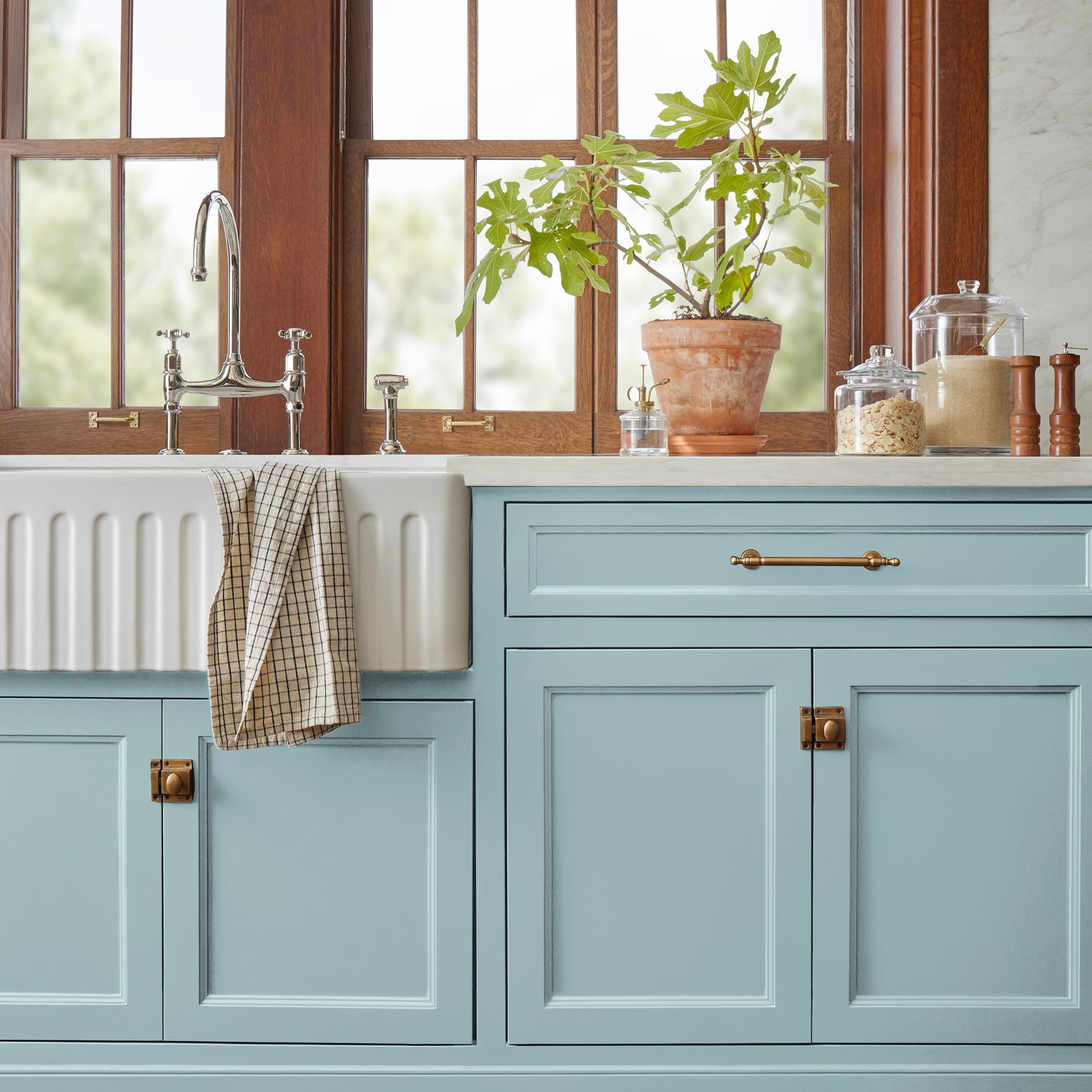 A muted blue door and cabinet paint named vibrant horizon shown painted on kitchen cabinet  