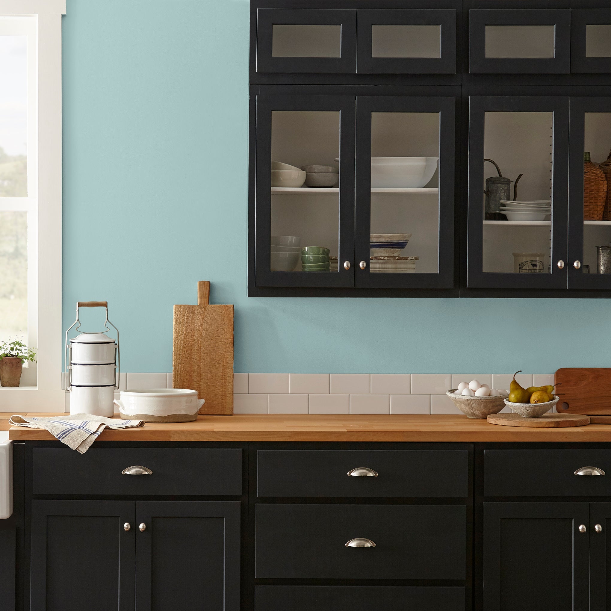 sky blue with grey undertone paint named it is well shown painted on kitchen wall