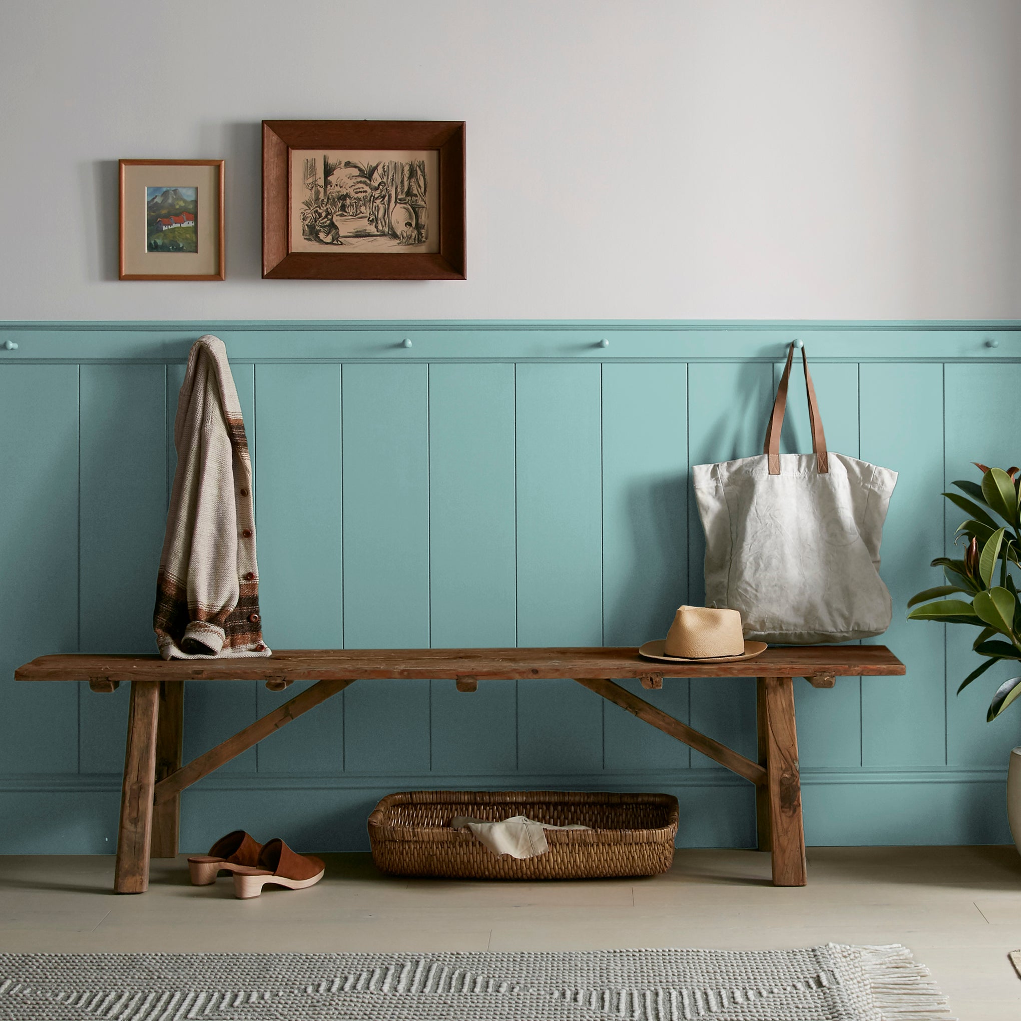 A cool aqua blue interior paint named morning calm shown painted on entryway wall