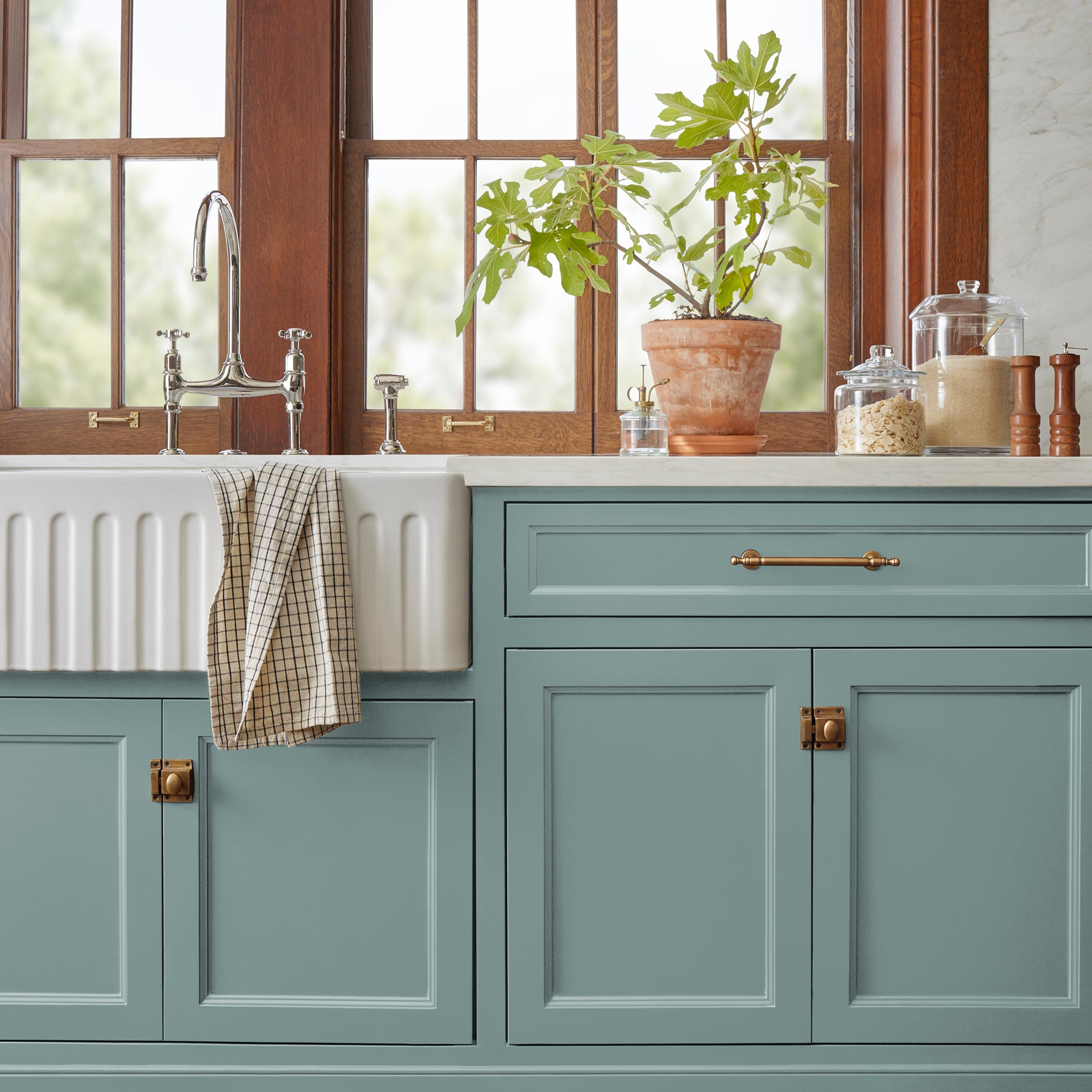 Ashy green with aqua undertones door and cabinet paint named well watered shown painted on kitchen cabinet  