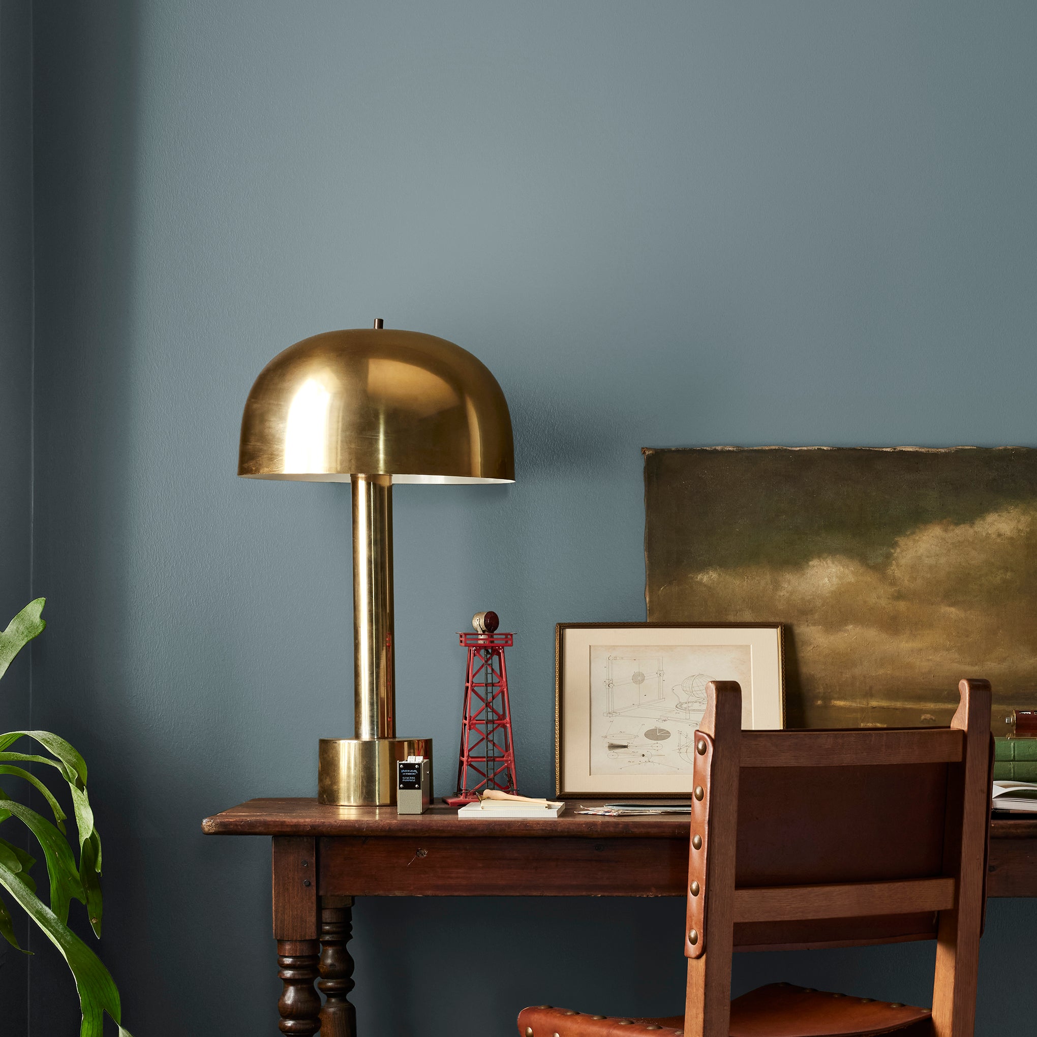 A grayed out blue interior paint named storm chaser shown painted on bedroom wall 